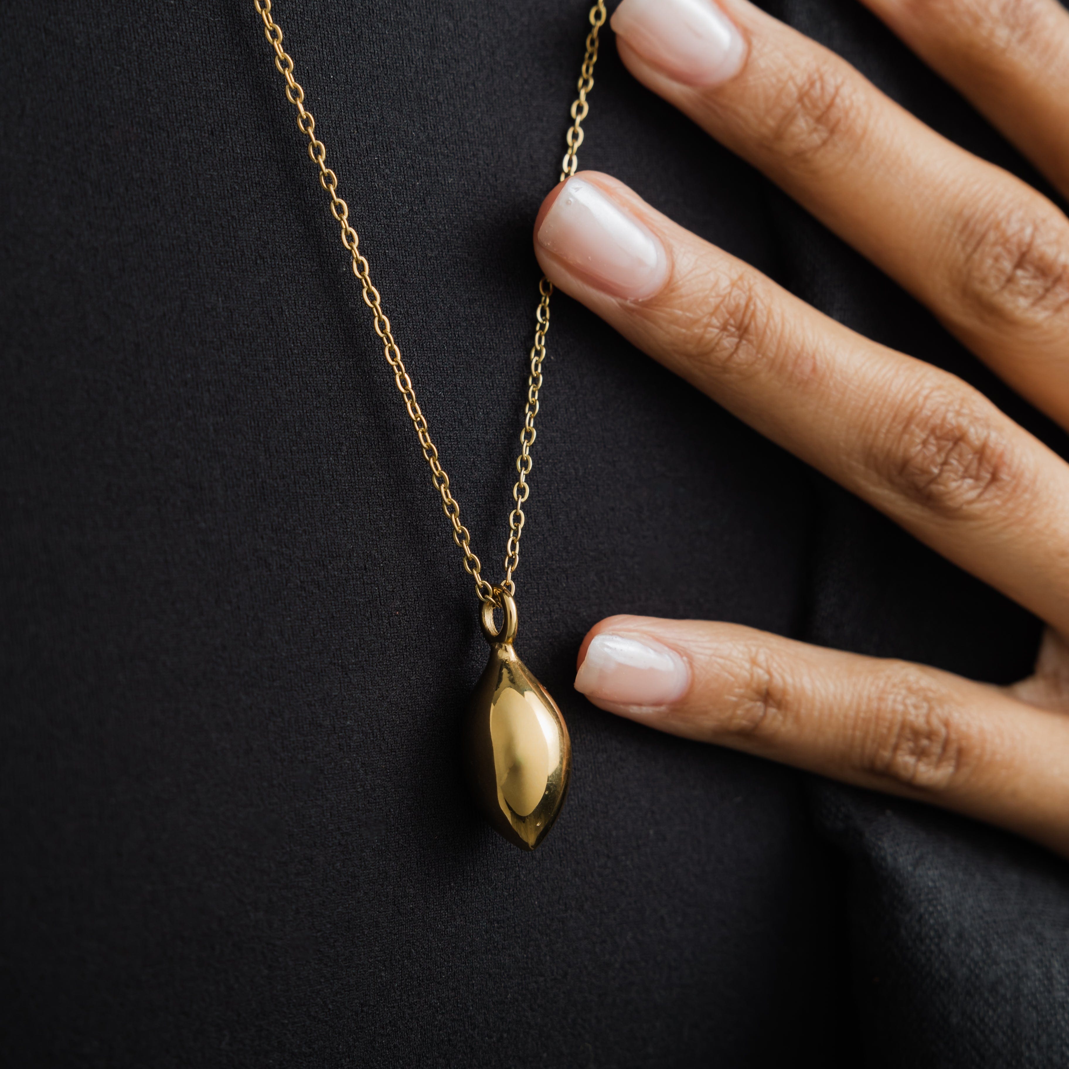 Model wearing the olive tree necklace, styled with casual attire to highlight its versatility.