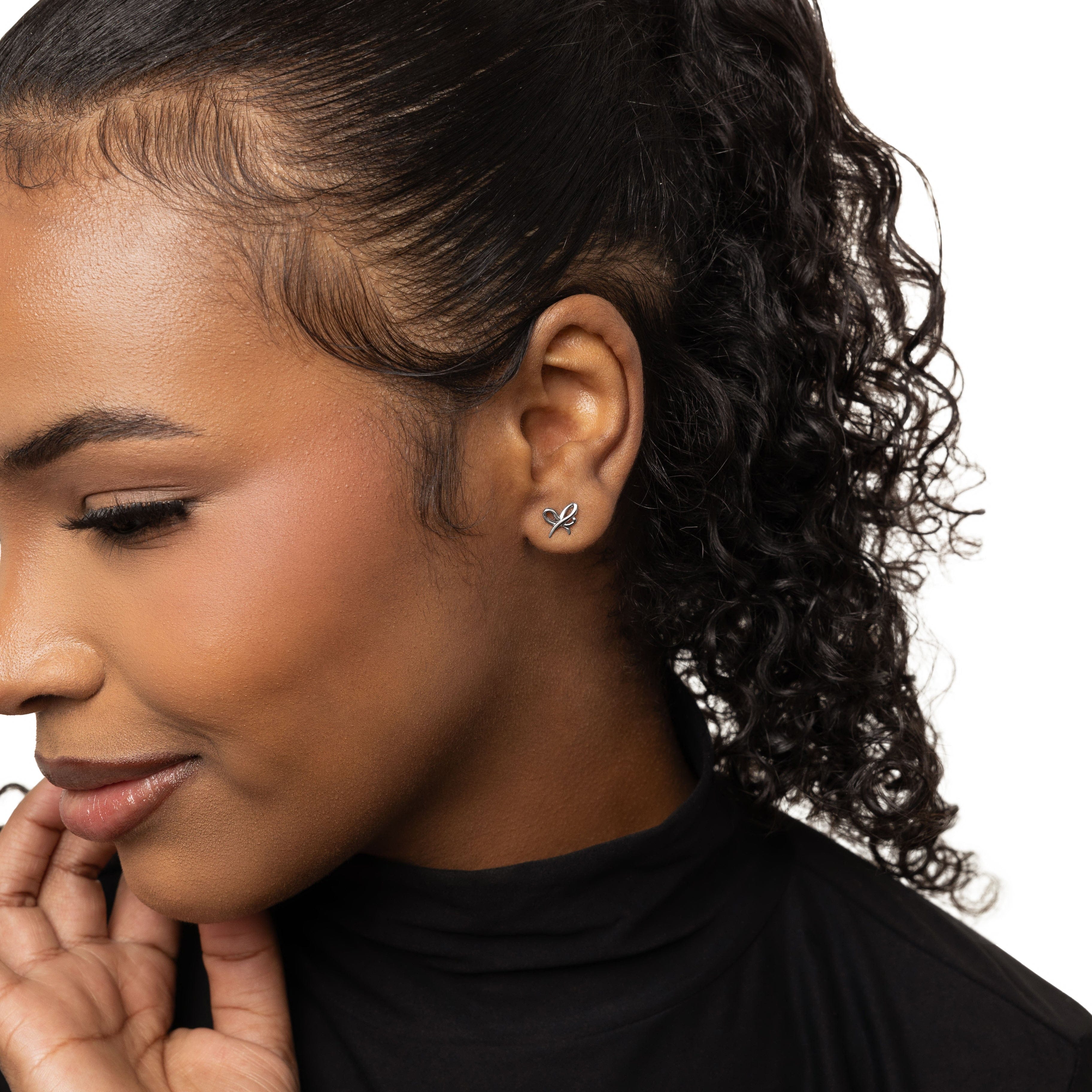 Elegant Mama Ribbon Studs showcasing their intricate design and gold finish.