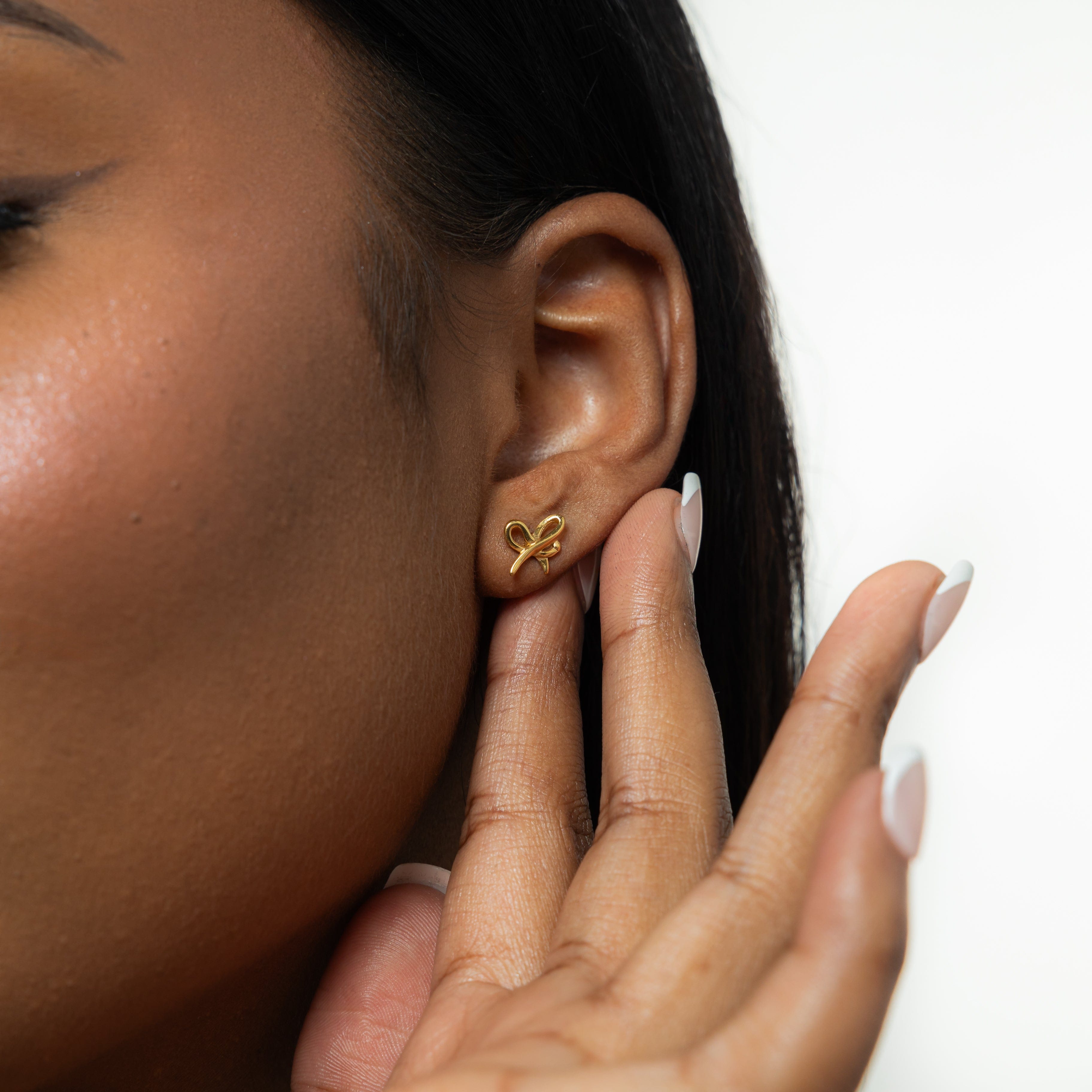 Elegant Mama Ribbon Studs showcasing their intricate design and gold finish.
