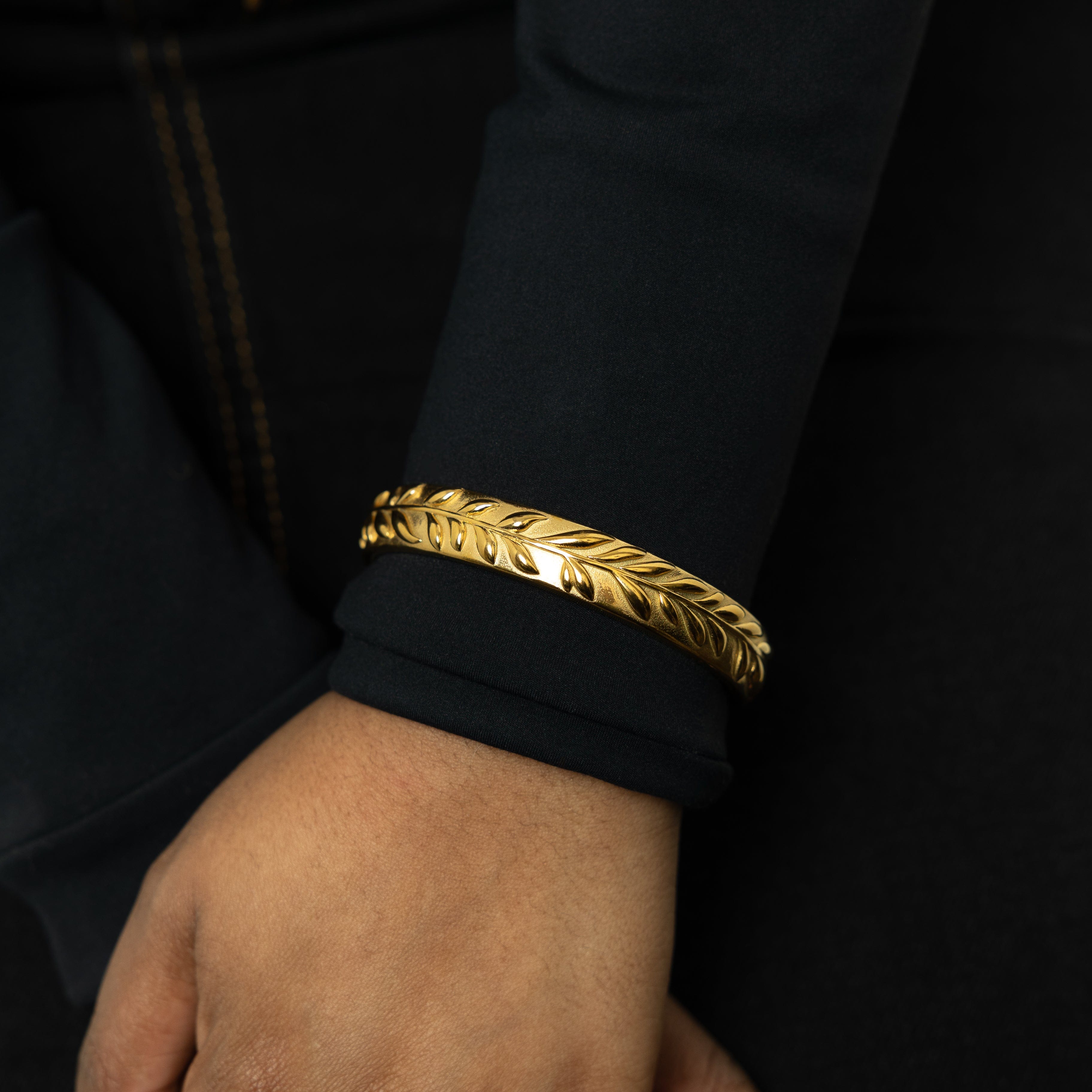 Model wearing the Olive Tree Resilience Cuff Bracelet, complementing a chic outfit for a statement look.