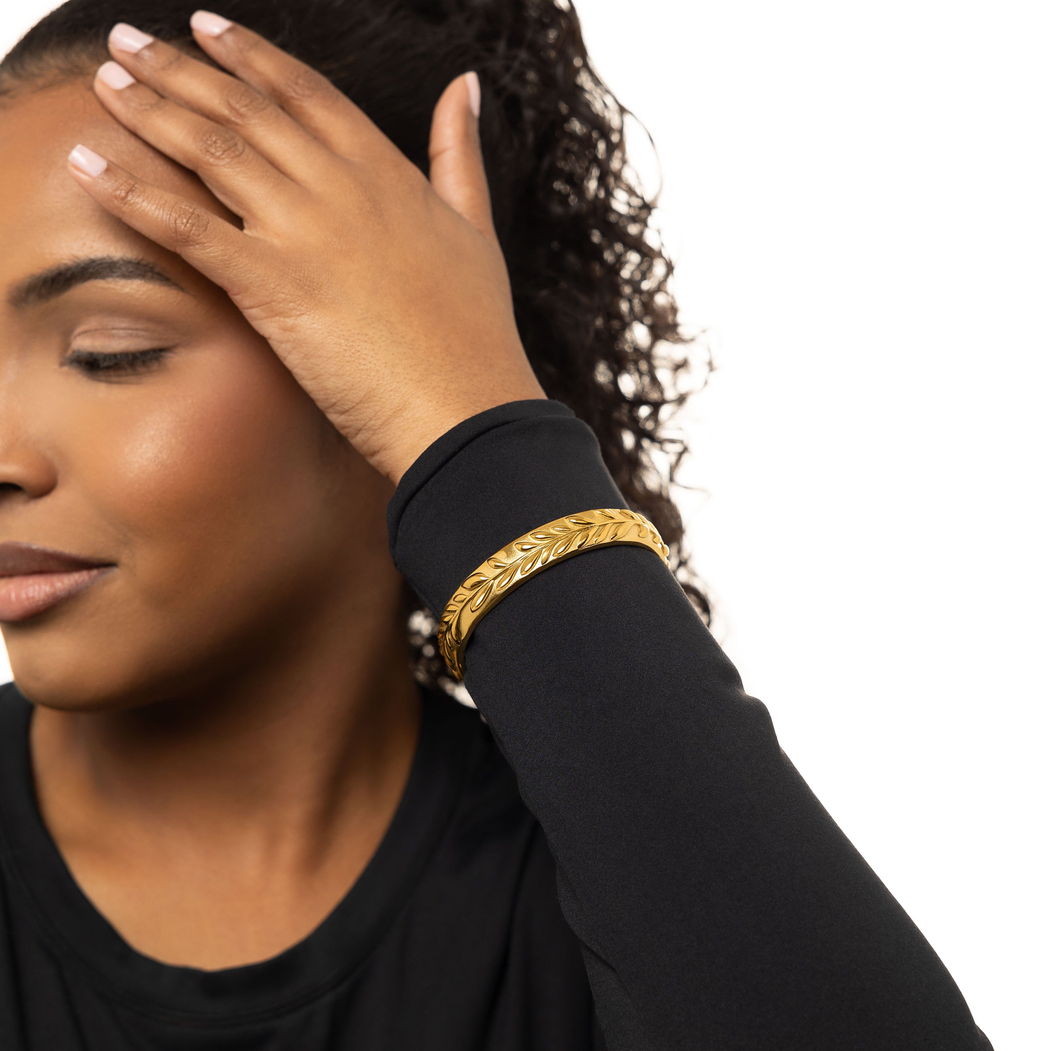 The Olive Tree Resilience Cuff Bracelet displayed in a velvet pouch, showcasing its elegant packaging.