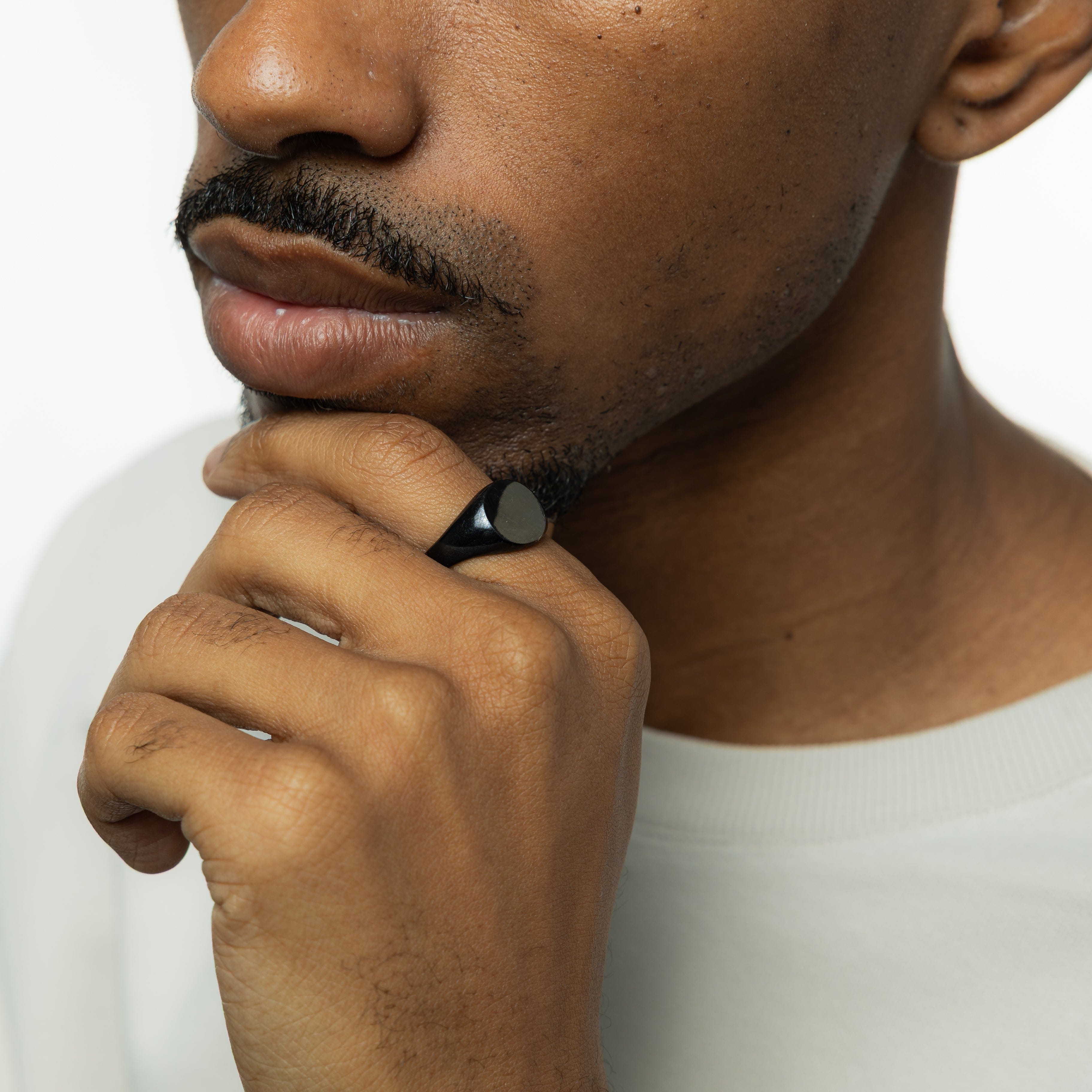Mens jewelry featuring the stainless steel signet ring, styled with other accessories.