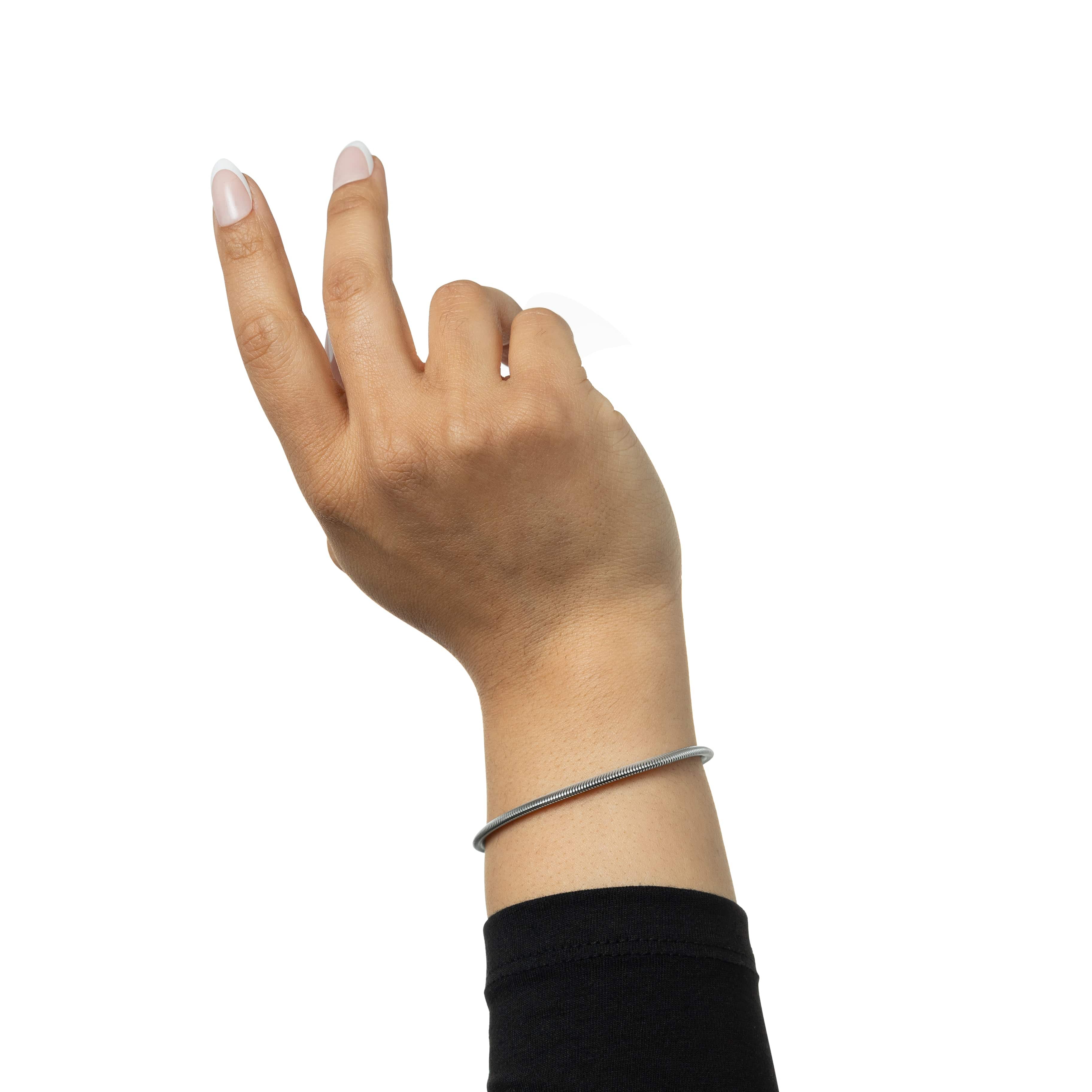 Close-up of the Liquid Gold Rounded Snake Bracelet on a wrist, highlighting its hypoallergenic features.
