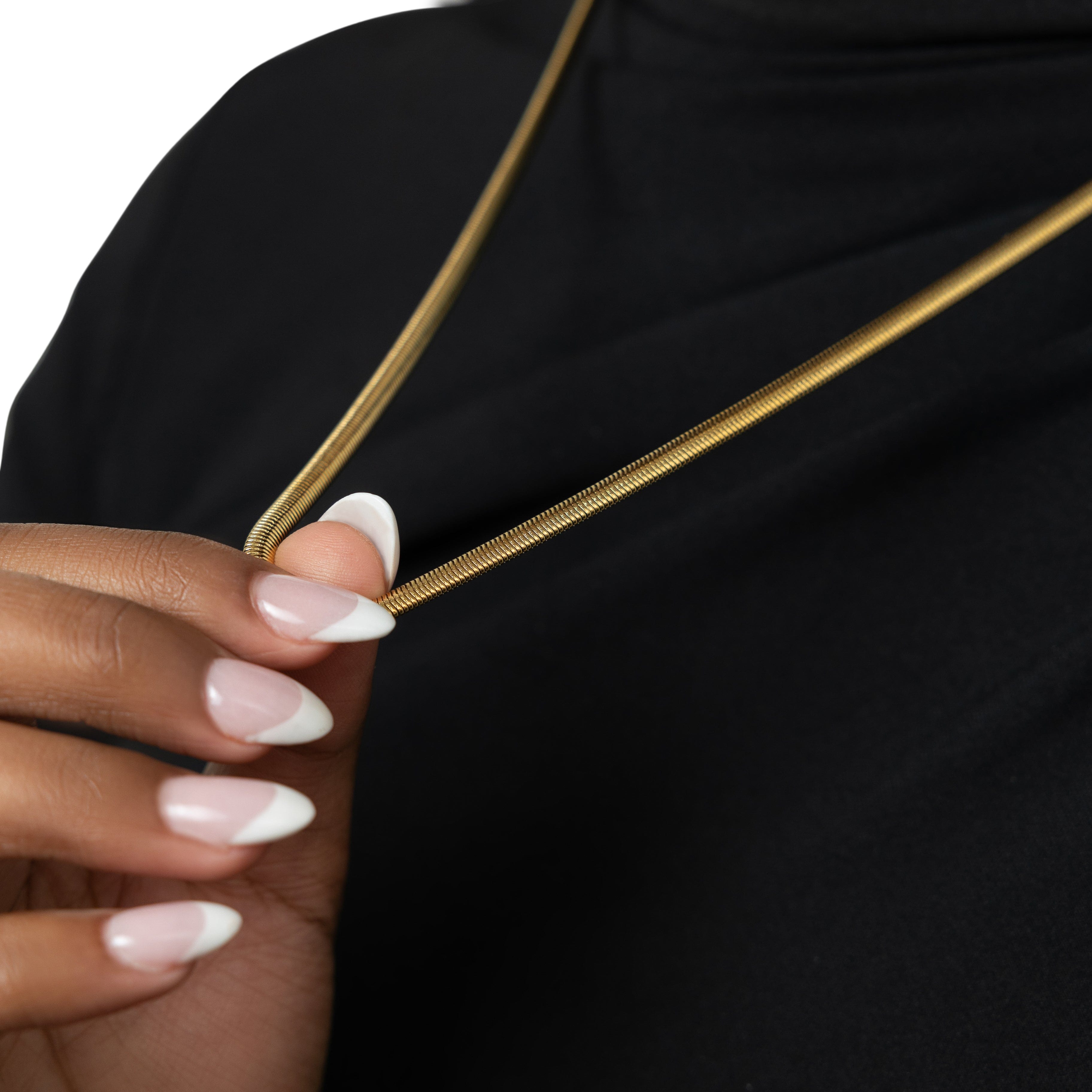 Elegant gold snake chain anklet displayed in a velvet pouch, showcasing its packaging.