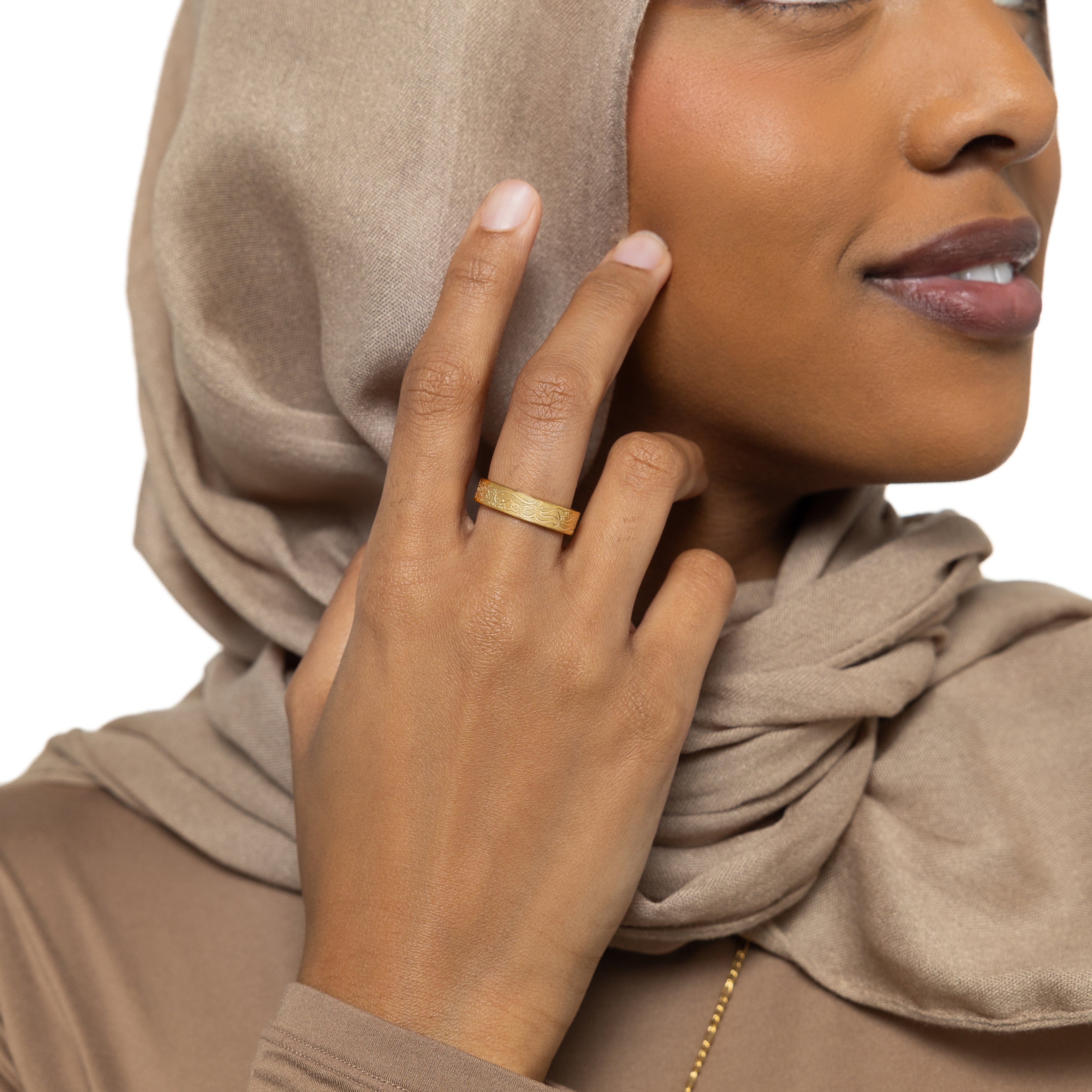 Product shot of the gold plated ring in its velvet pouch, ready as a motivational jewelry gift for her.