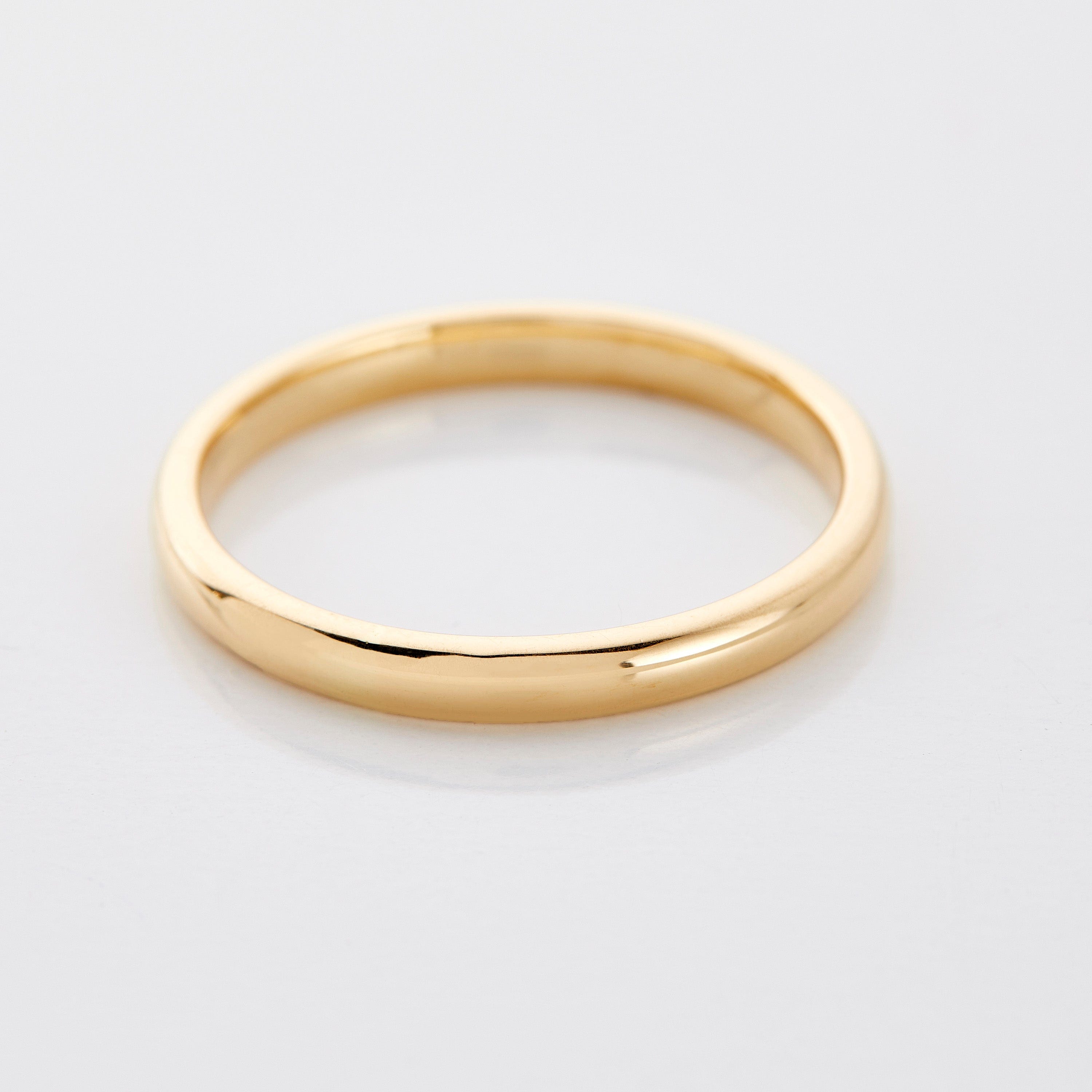 Close-up view of the Eternal Minimalist Gold Stacking Ring showcasing its smooth finish and thin band design.