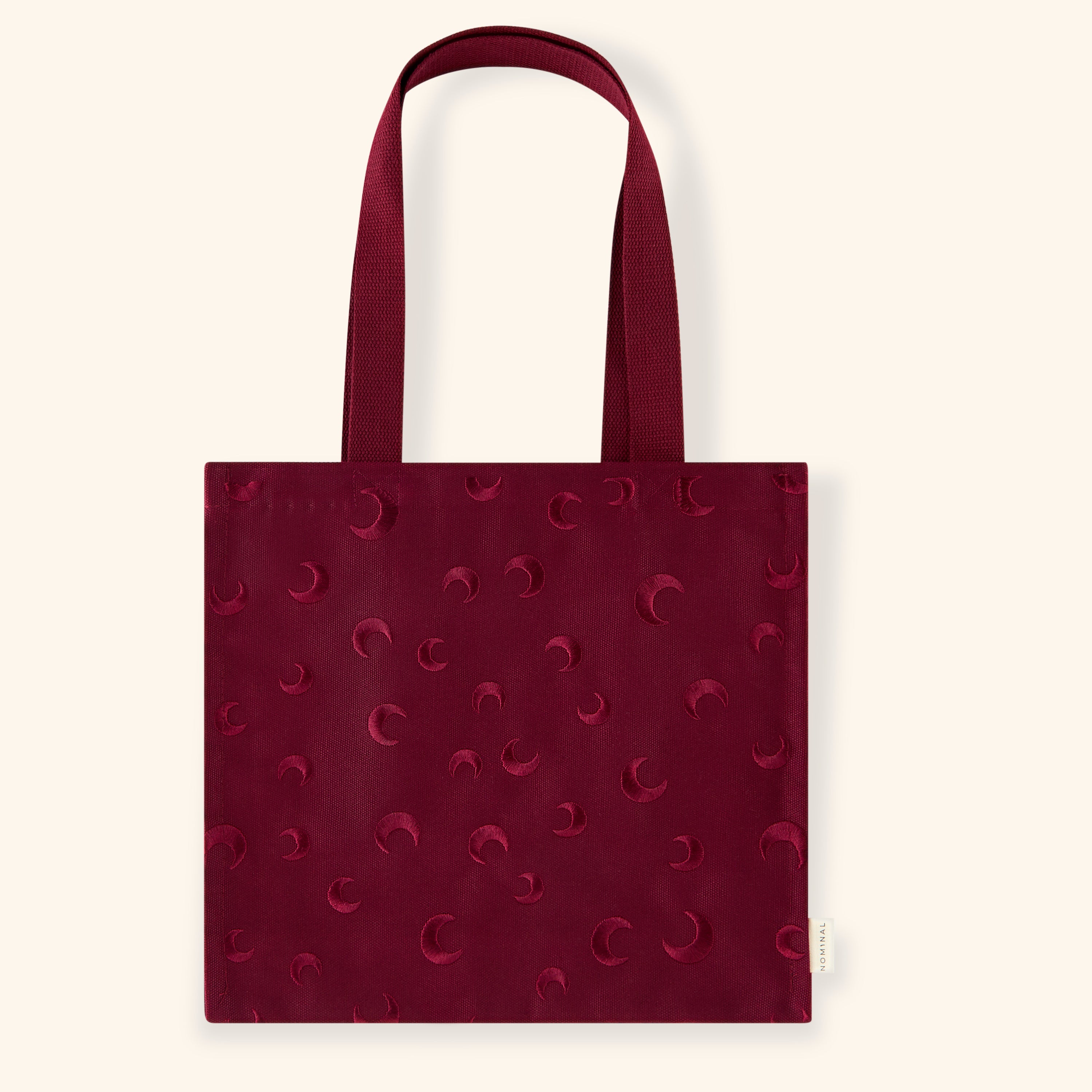 Celestial Charm fashion tote showcasing embroidered design and deep red color from the front angle.
