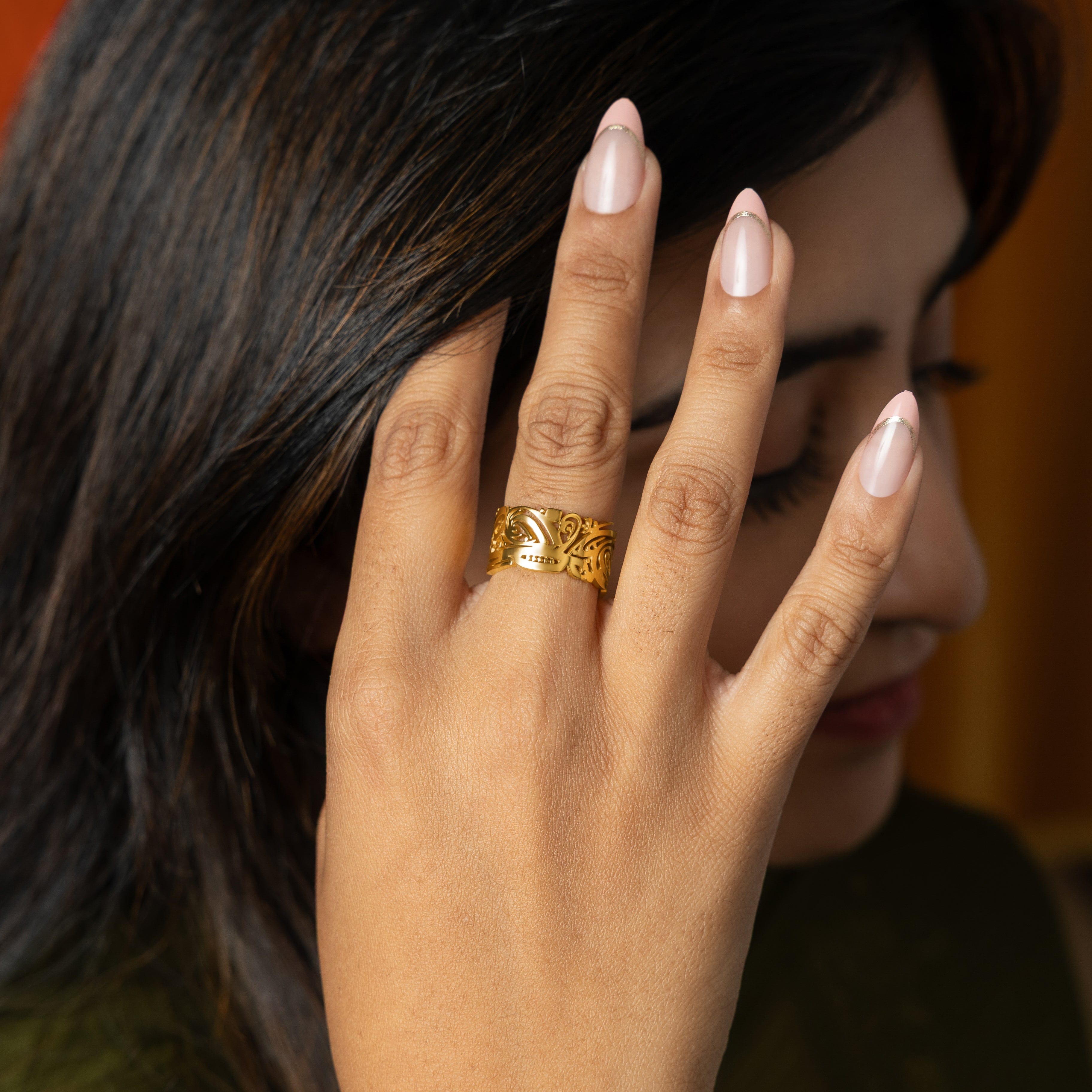 Side view of the EASE ring, showcasing its 10MM band width and gold plated finish.