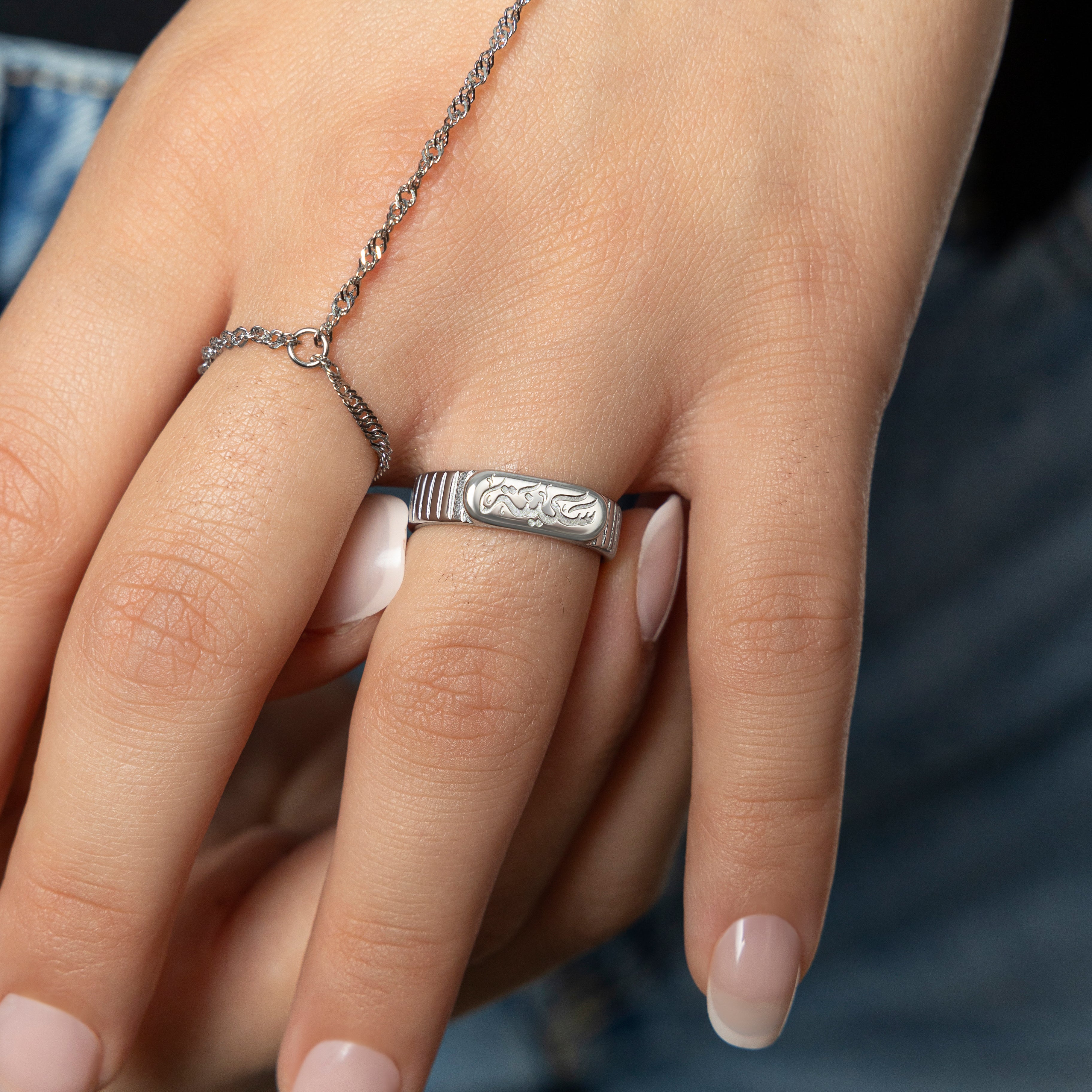 Close-up of the gold plated ring showing Sakinah Arabic engraving and oval top detail