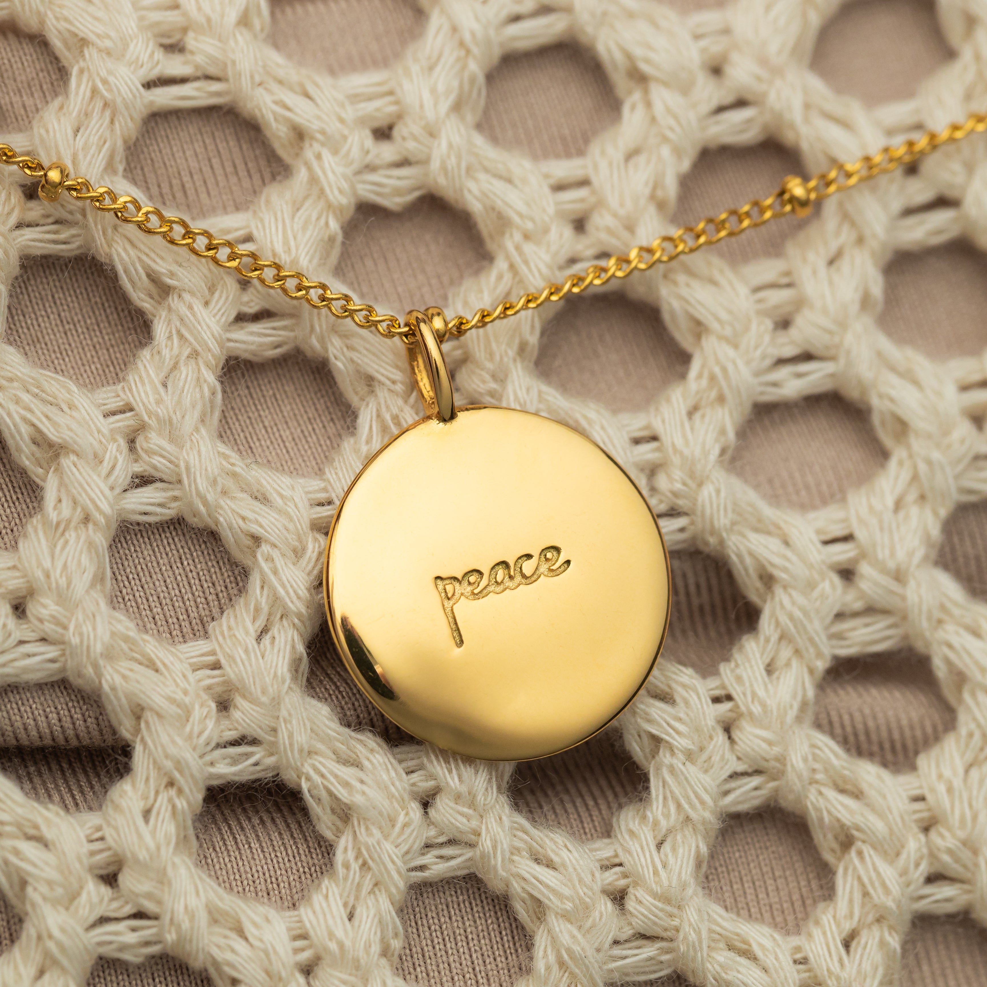 Personalized charm necklace displayed on a minimalist background.