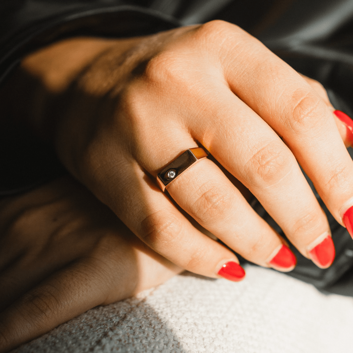 Woman wearing GlimmerBar signet ring in daily outfit — perfect for sensitive skin