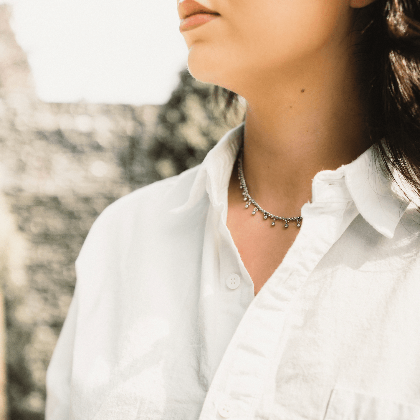 Model wearing the Luna choker at 14" length layered with other dainty jewelry — perfect for everyday styling