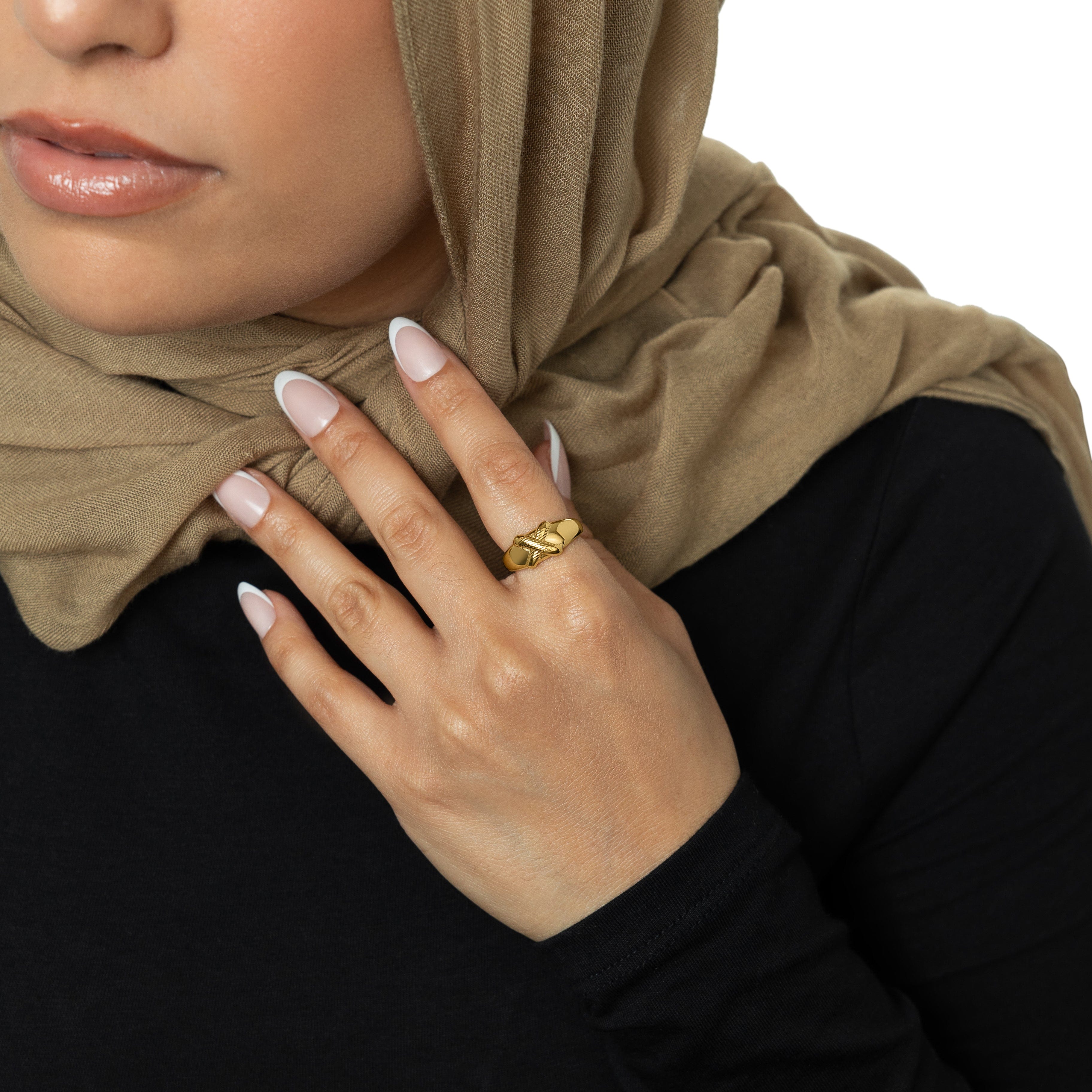 Empower Your Impact Gold Ring worn by a woman in an outdoor setting, highlighting its waterproof feature.