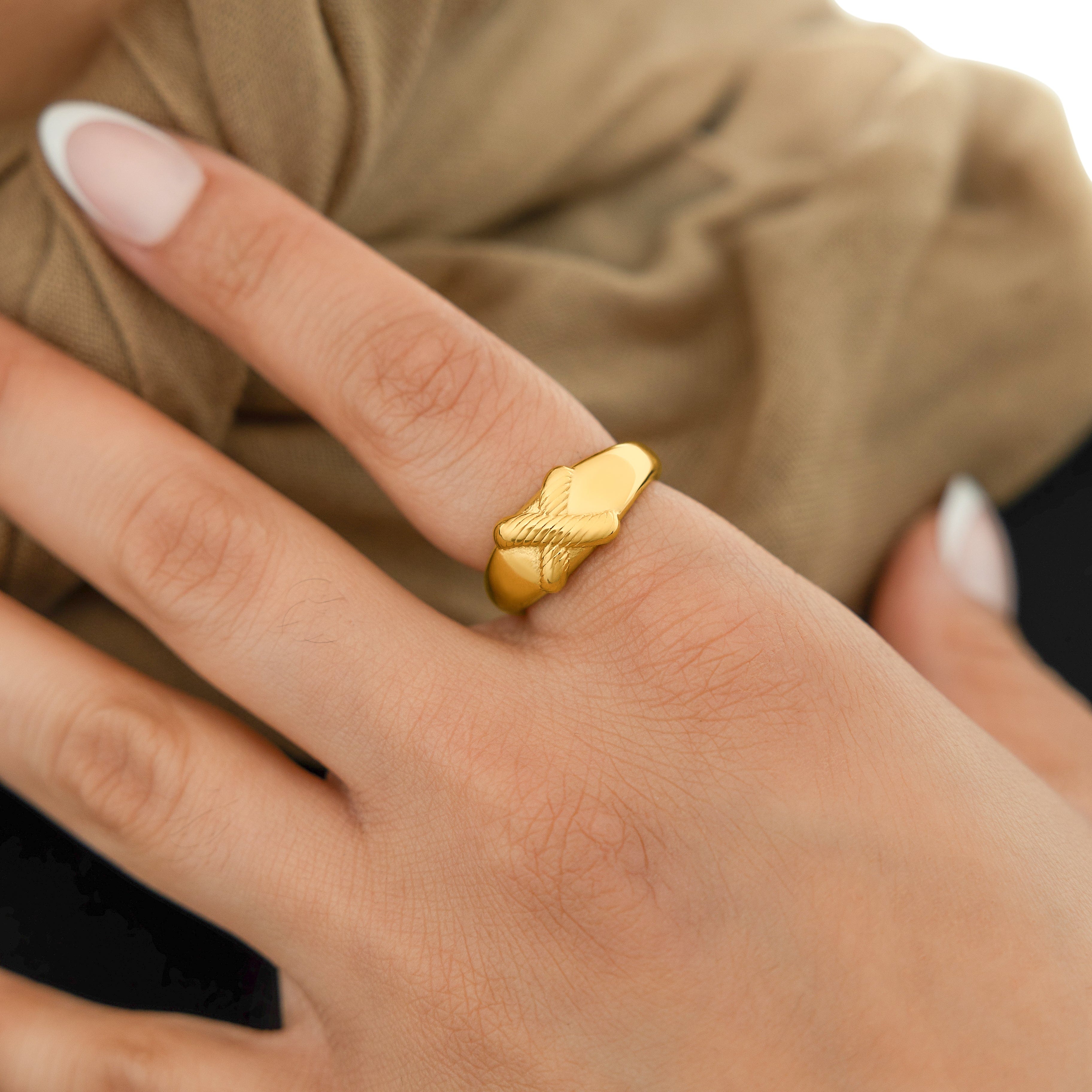 Empower Your Impact Gold Ring worn by a woman in an outdoor setting, highlighting its waterproof feature.
