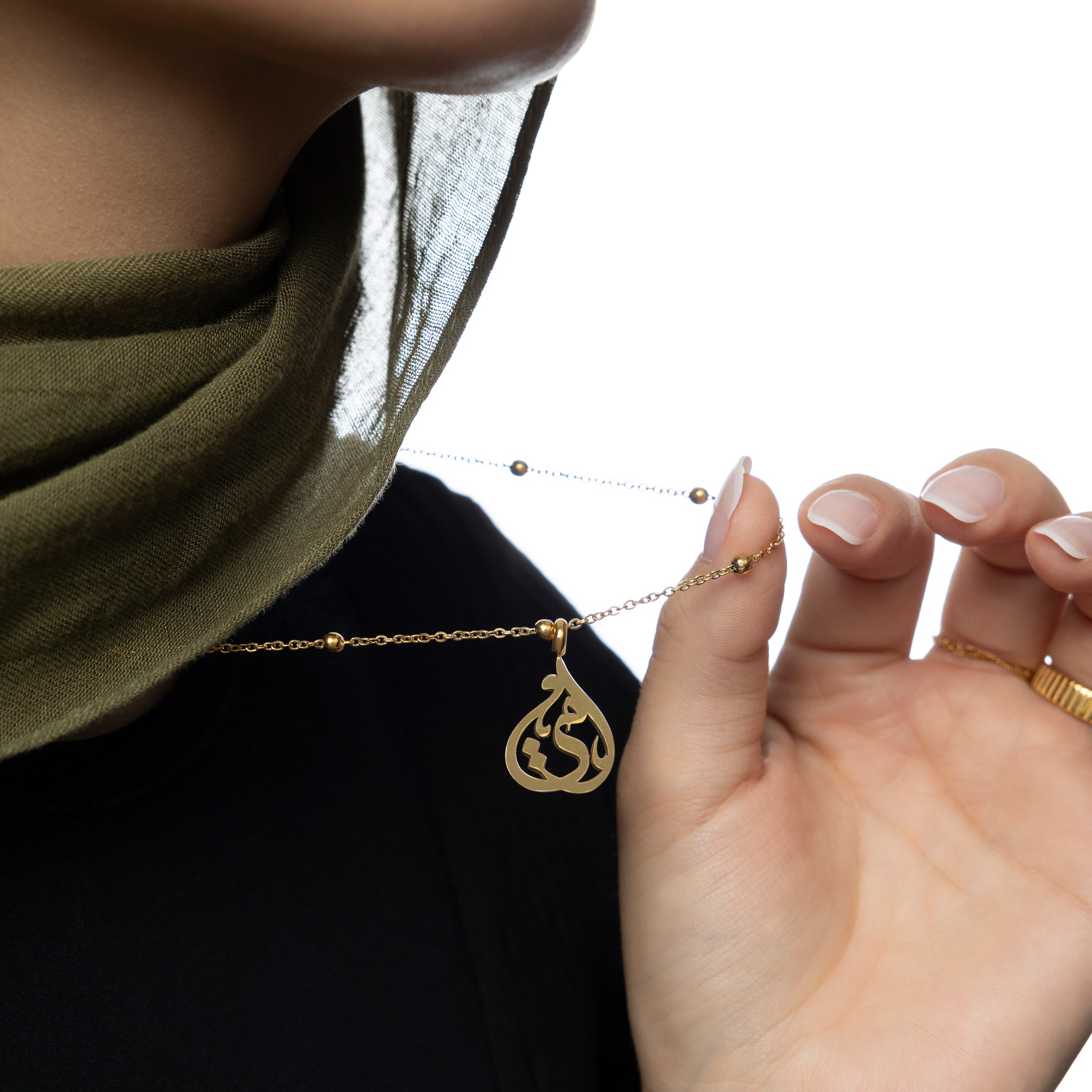 Model wearing the affordable sister necklace with calligraphy outdoors