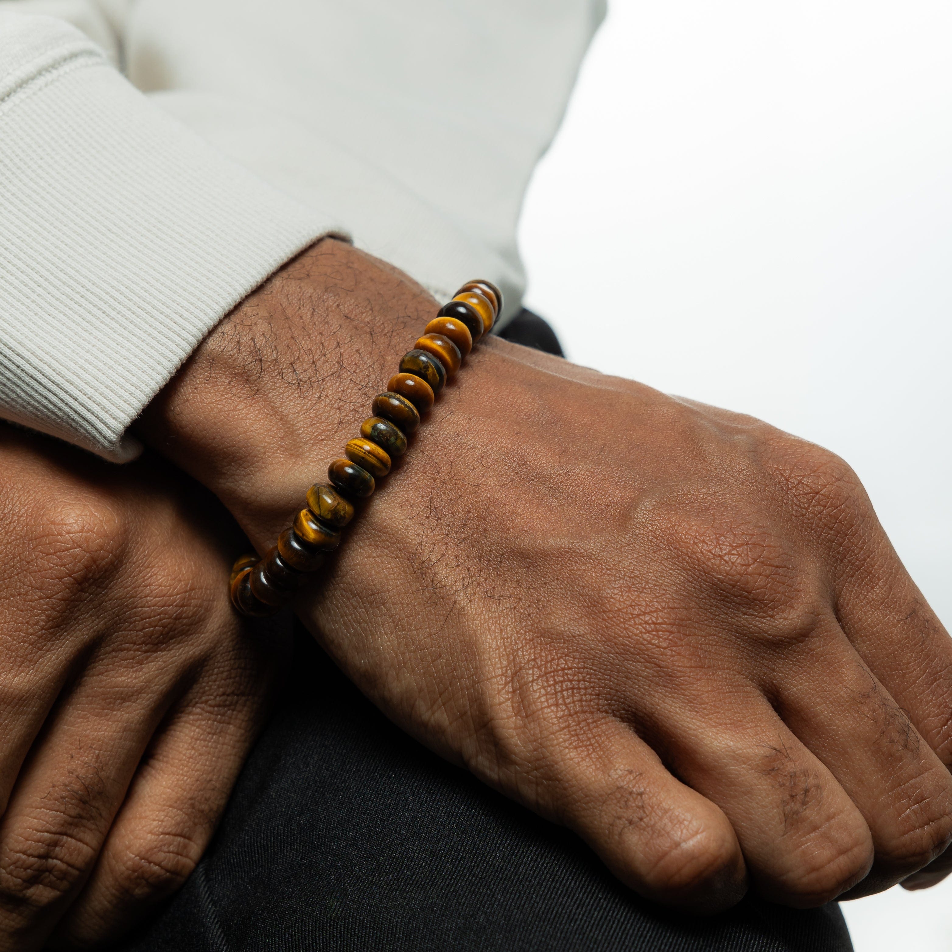 Tigers Eye bead bracelet worn by a man, highlighting its stylish design.