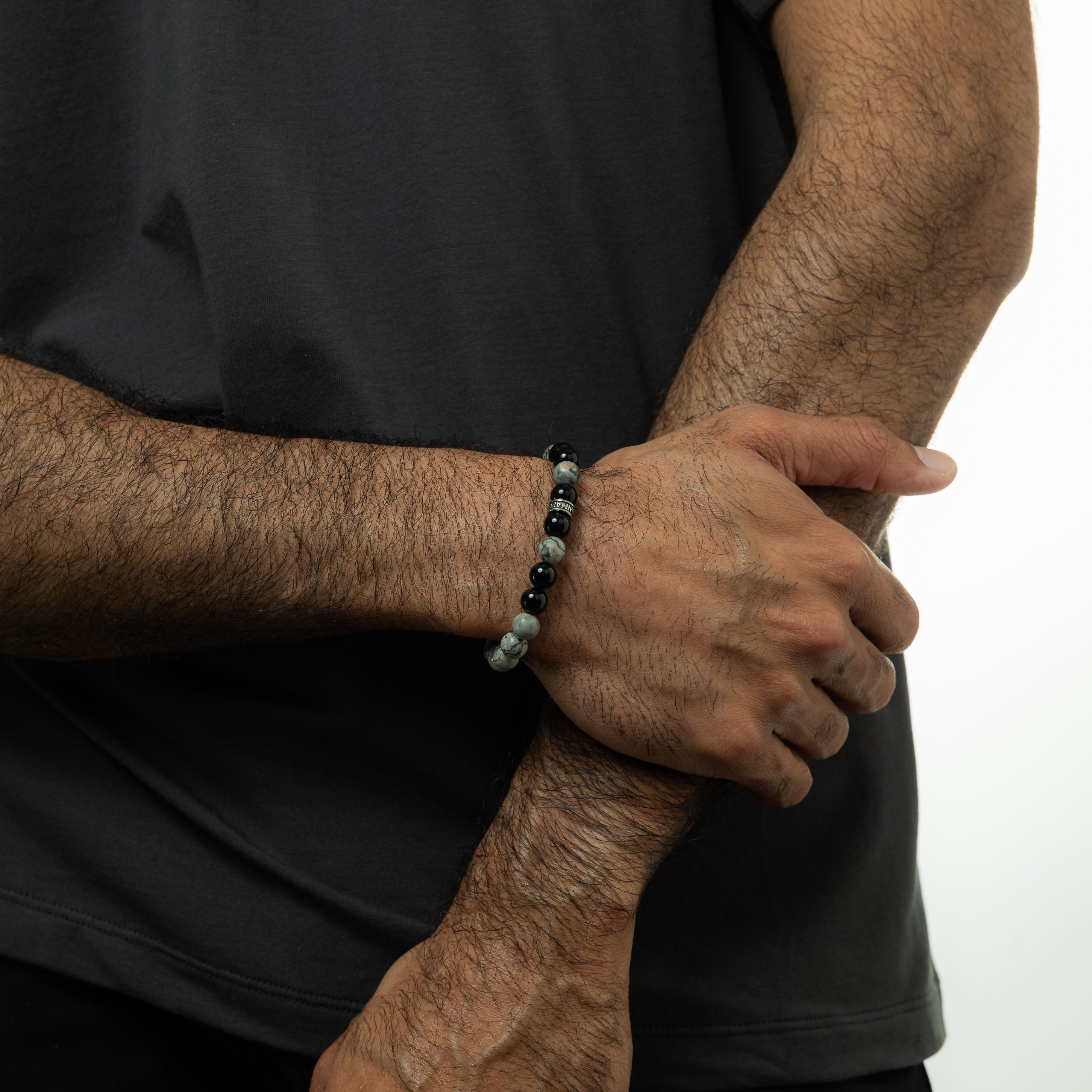 Model wearing the Kosmos Storm stone bracelet, demonstrating its elegant design in a casual outfit.