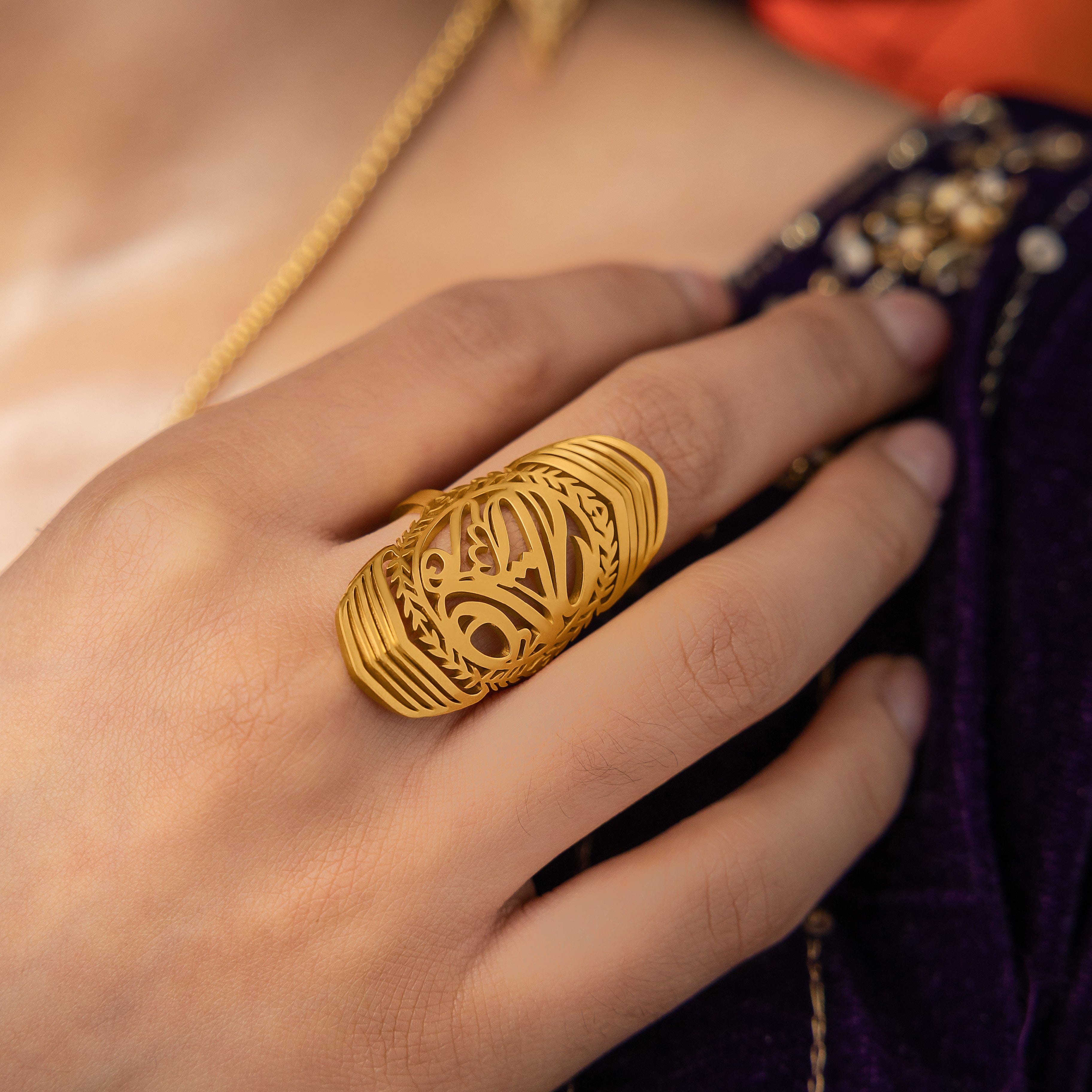 Close-up of the Sufficient Strength Ring demonstrating its gold plating and elegant design.