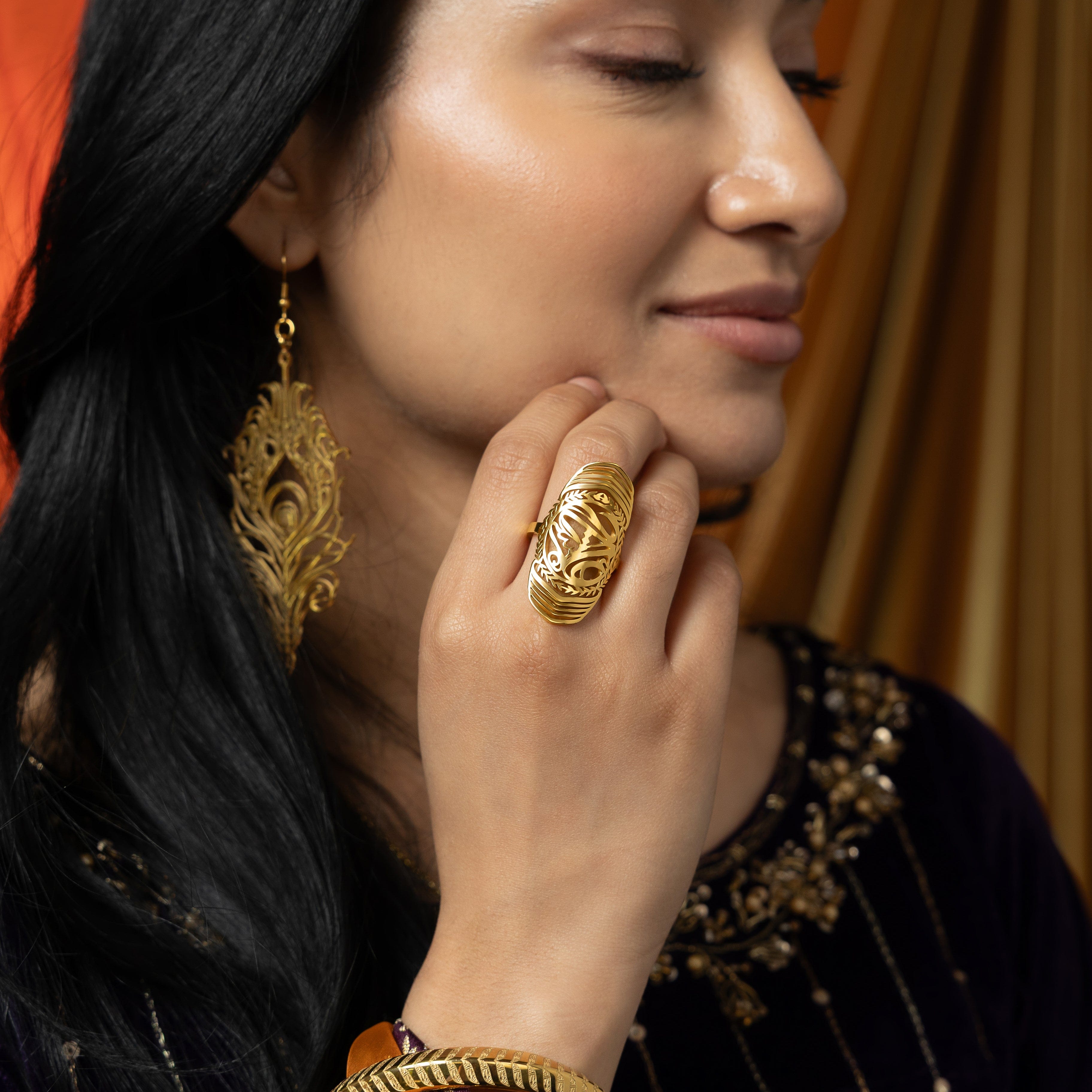 Close-up of the Sufficient Strength Ring demonstrating its gold plating and elegant design.