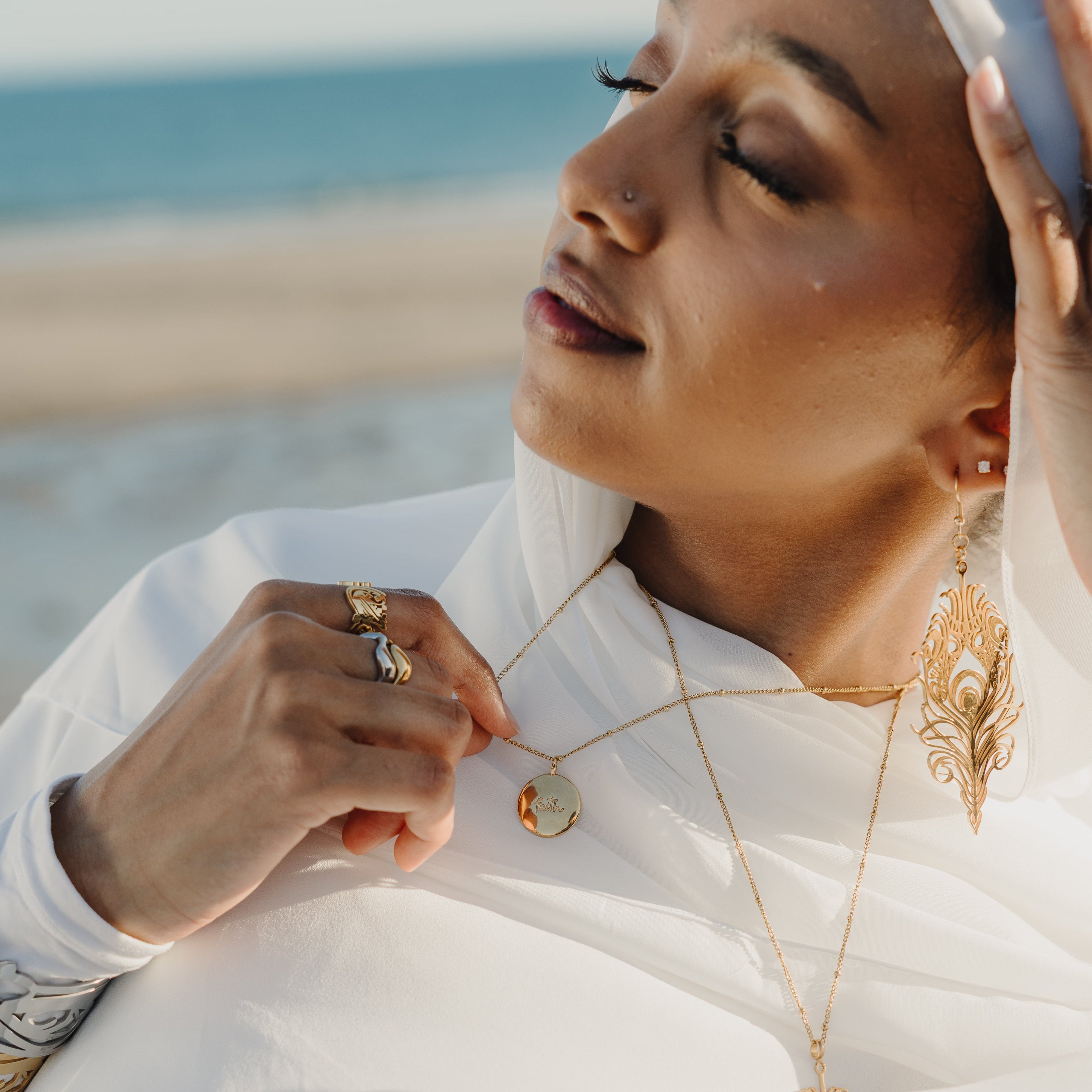 Iman Faith Charm styled on a delicate necklace, perfect for everyday wear.