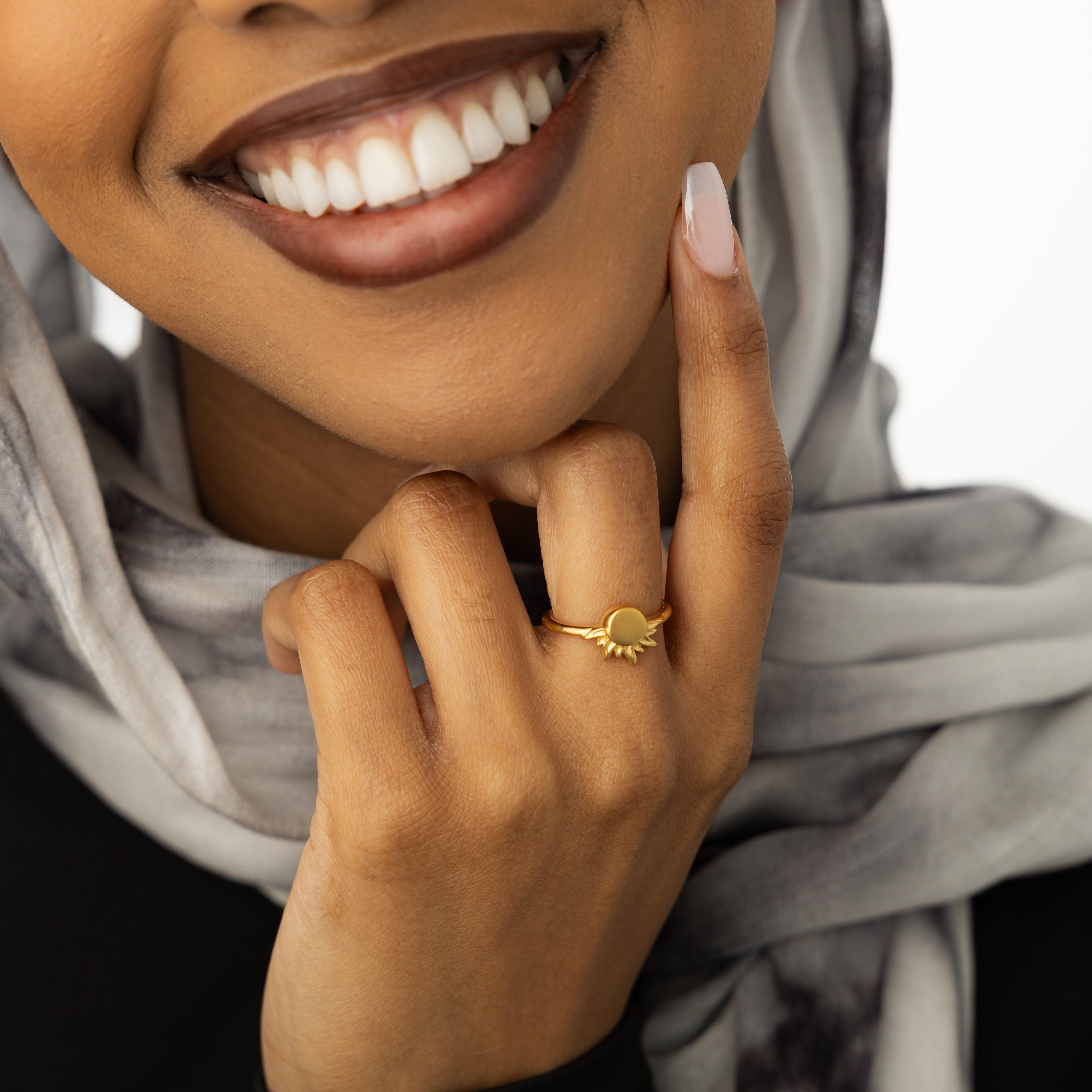 Radiant Sun Ring worn alongside other stackable rings, showcasing its versatility.