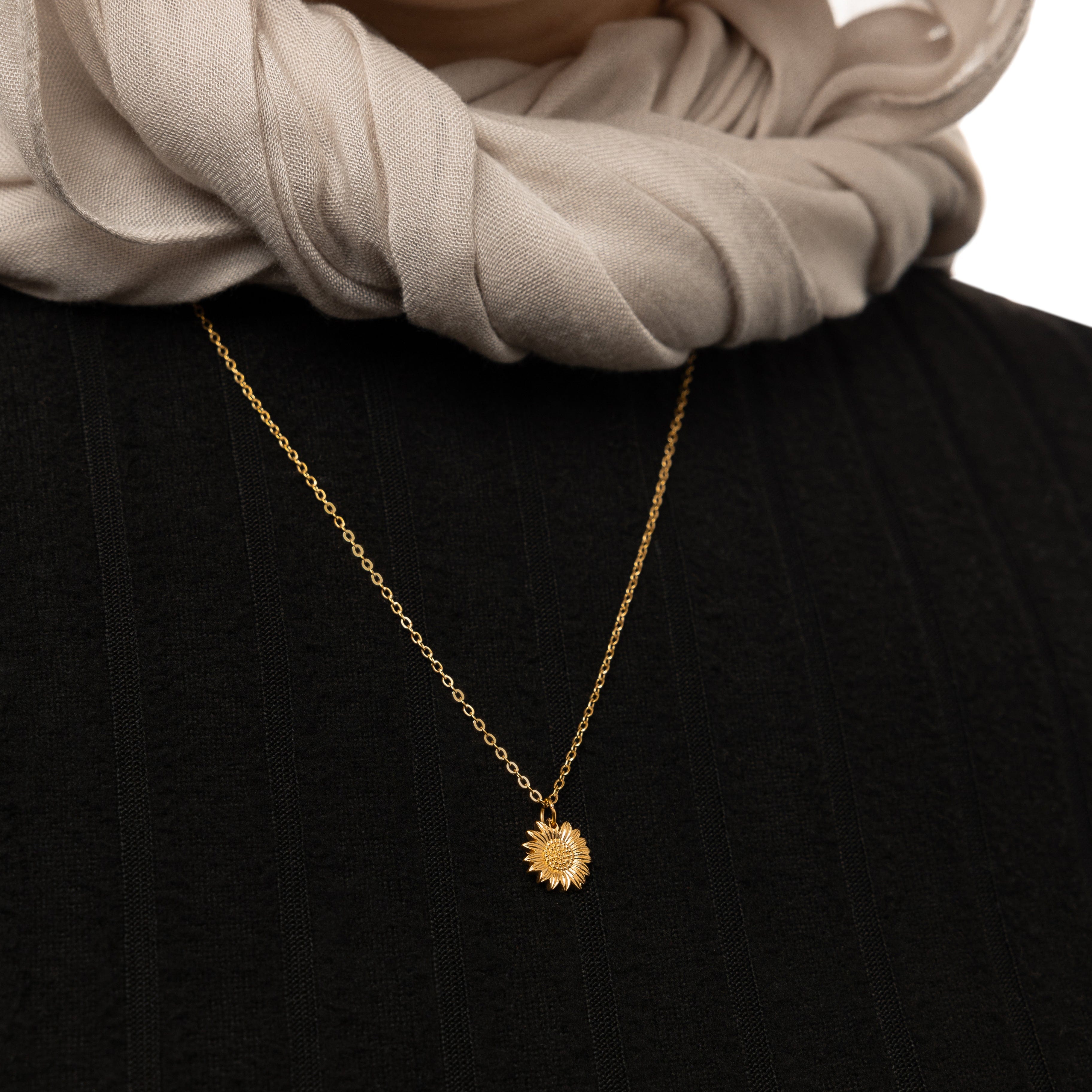 Model wearing the sunflower necklace, styled with casual attire for a chic look.