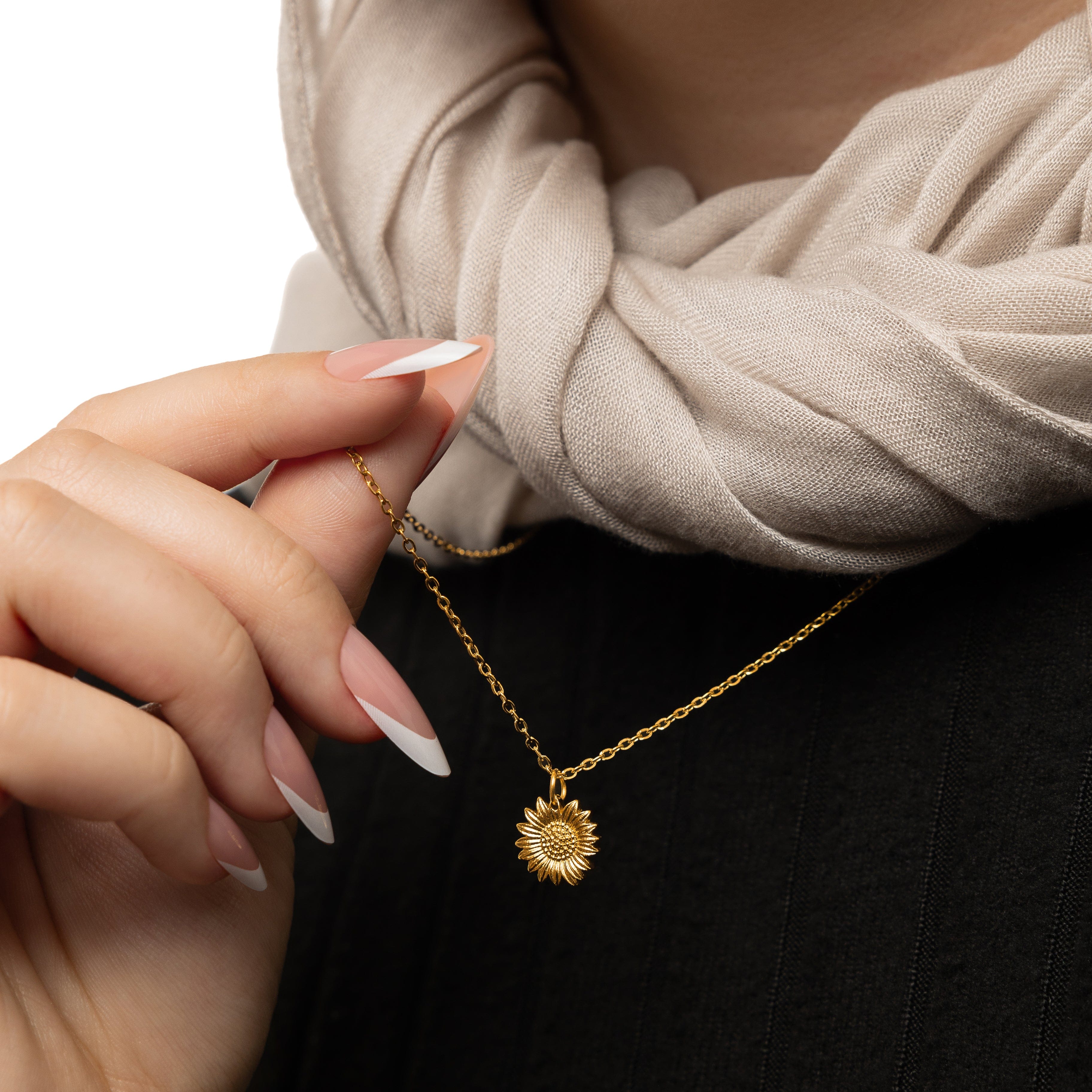Close-up of the radiant sunflower necklace highlighting its delicate details.