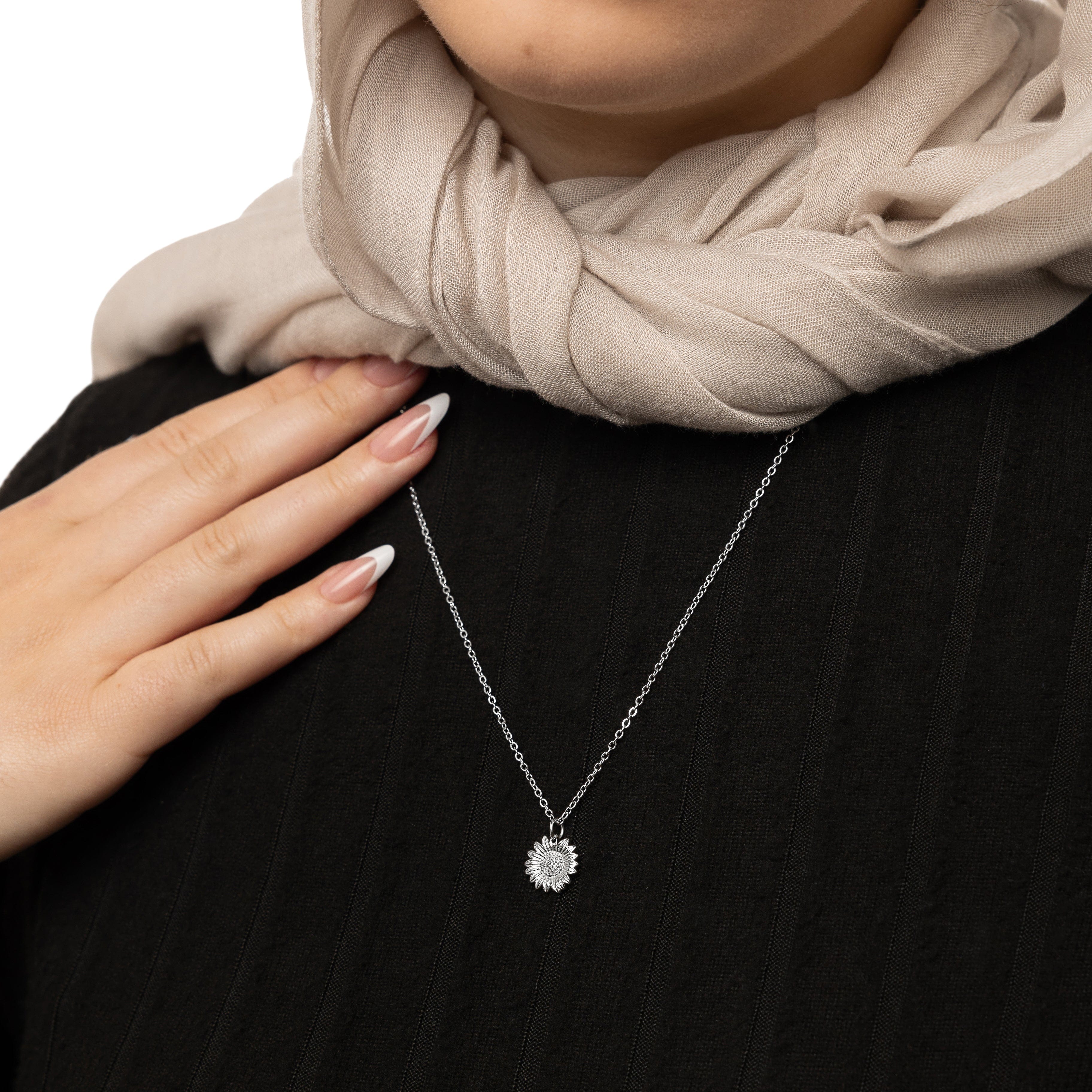Close-up of the radiant sunflower necklace highlighting its delicate details.