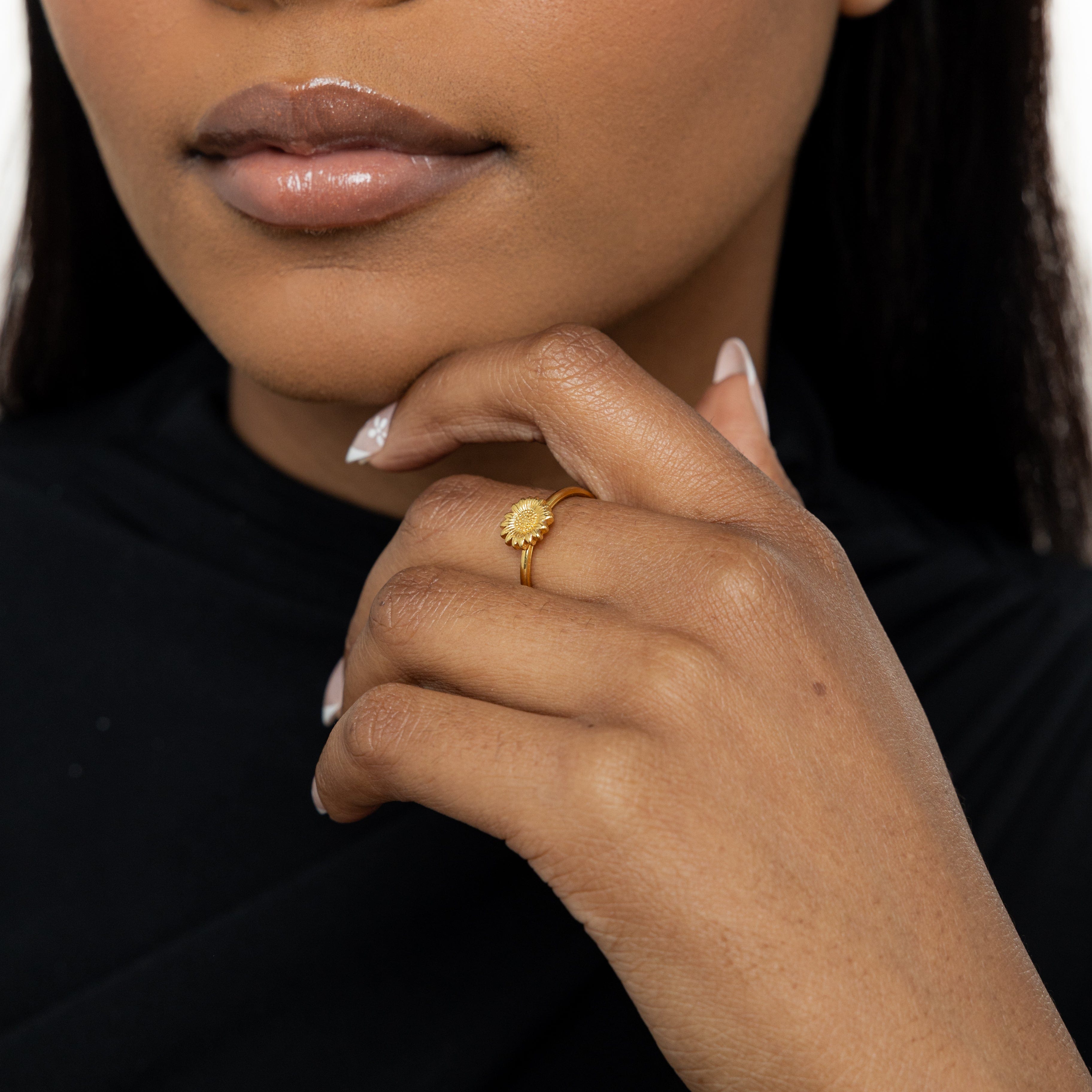 Close-up view of the radiant sunflower stackable ring showcasing its gold plating and intricate design.