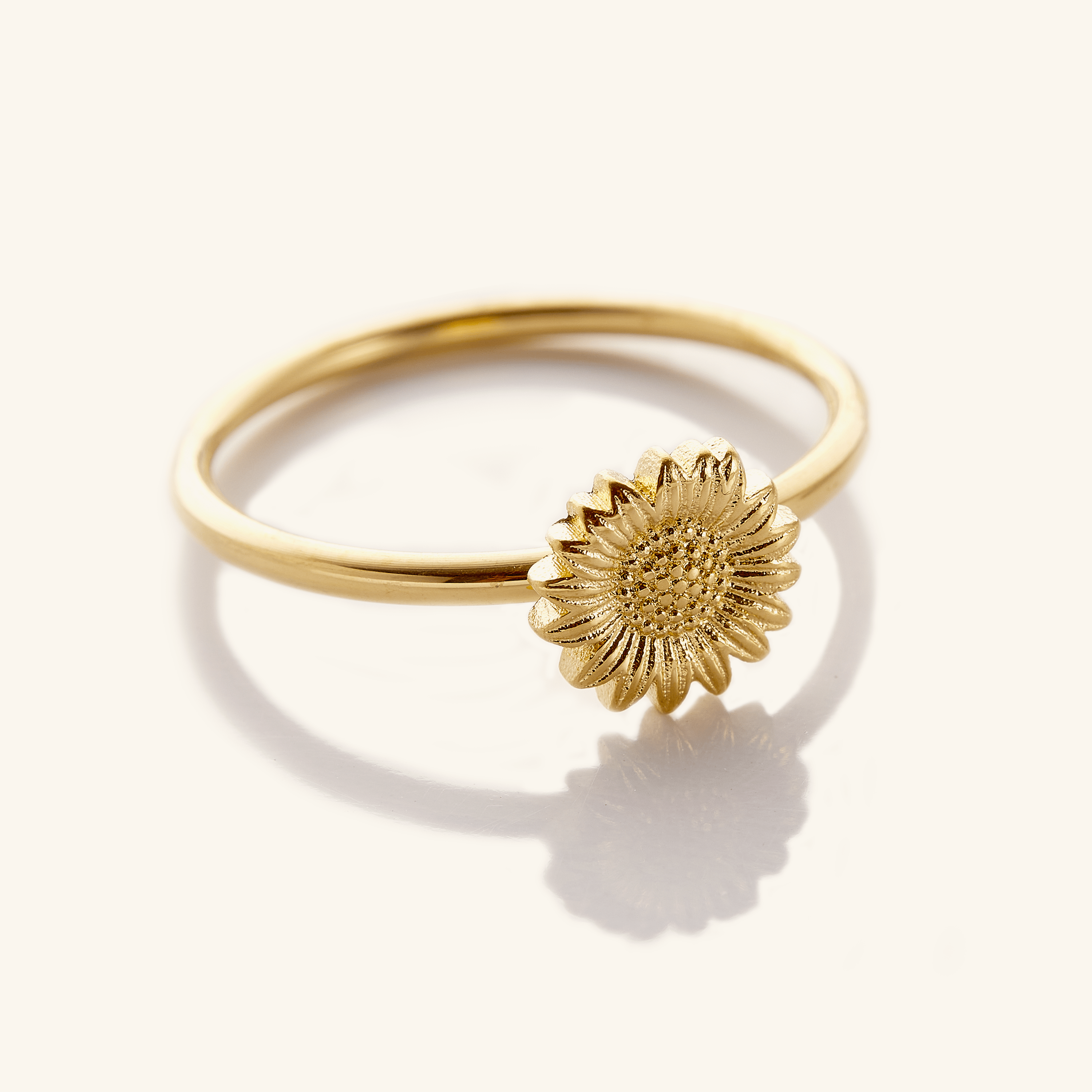 Close-up view of the radiant sunflower stackable ring showcasing its gold plating and intricate design.