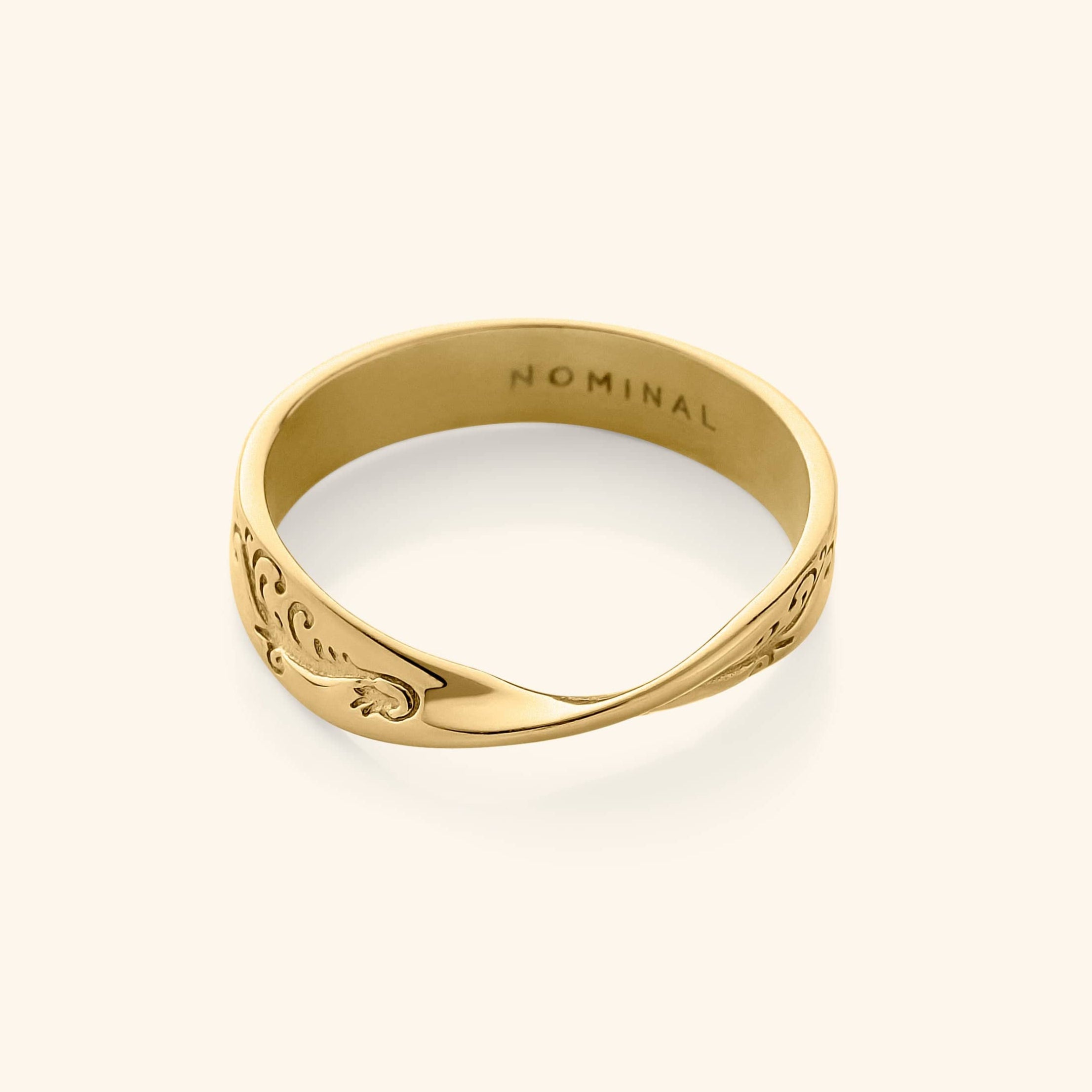 Close-up of the wave ring showing its spiral centerpiece and detailed engravings