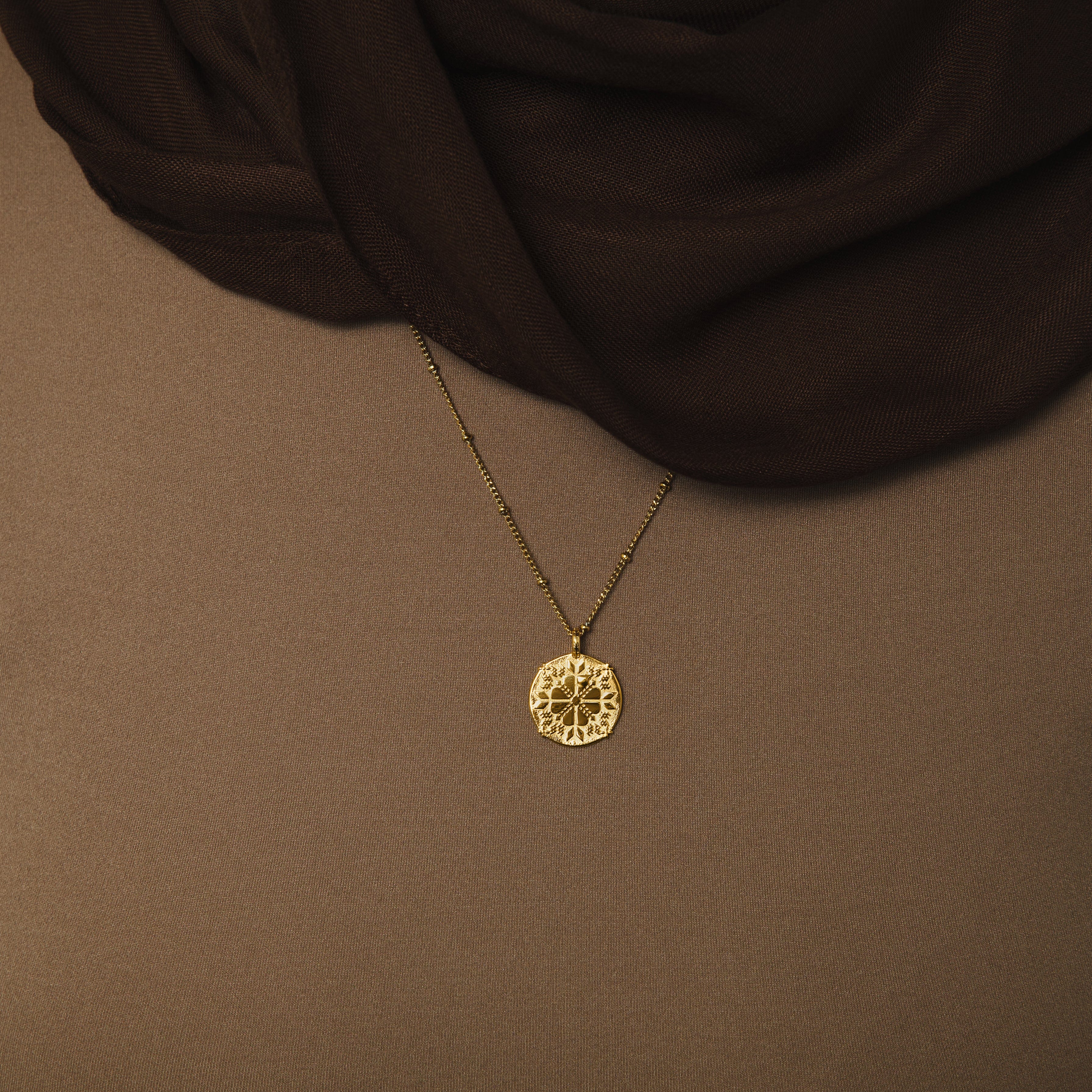 Tatreez necklace worn by a model, demonstrating its versatility and cultural significance.