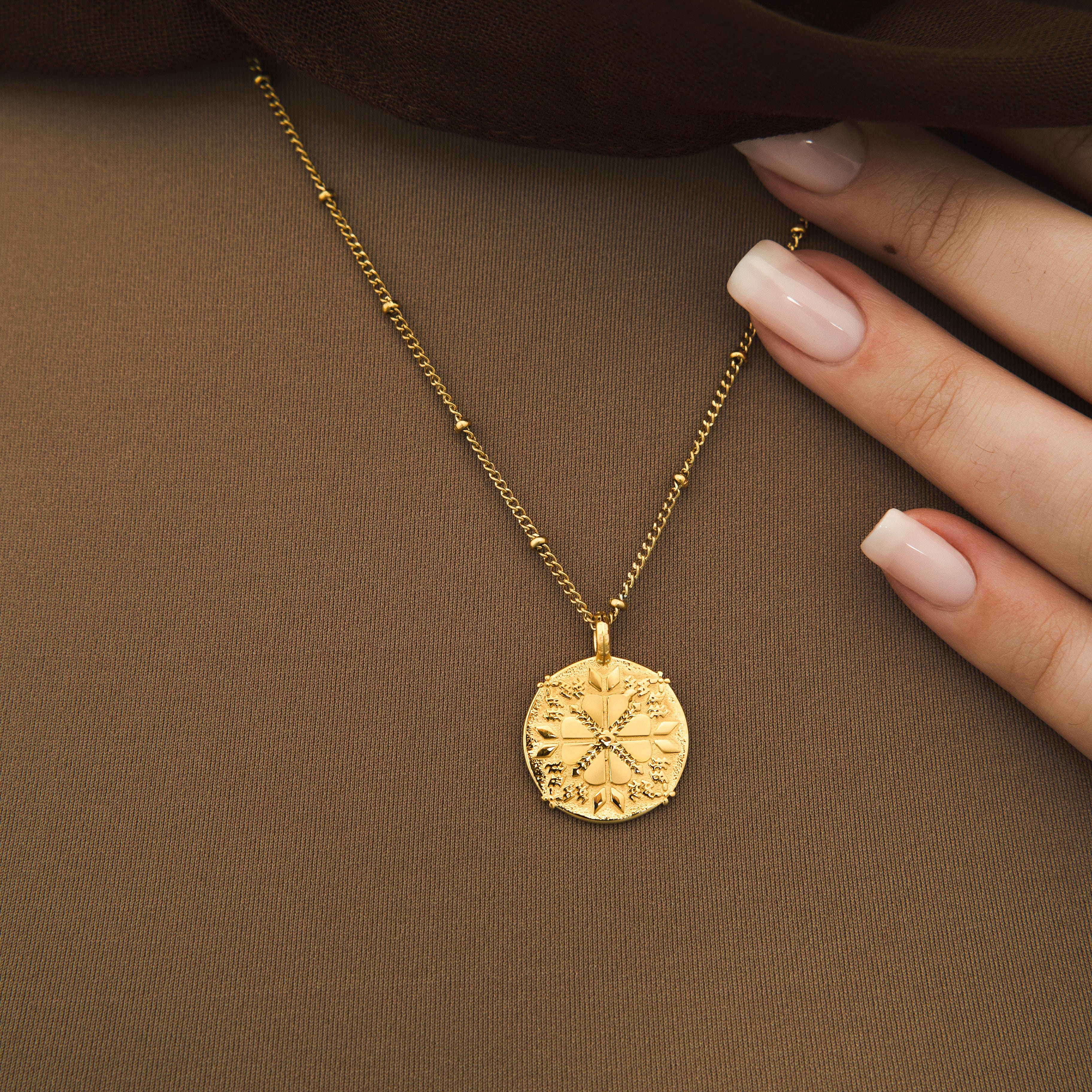 Close-up of the 18k gold plated tatreez necklace showing its detailed craftsmanship.