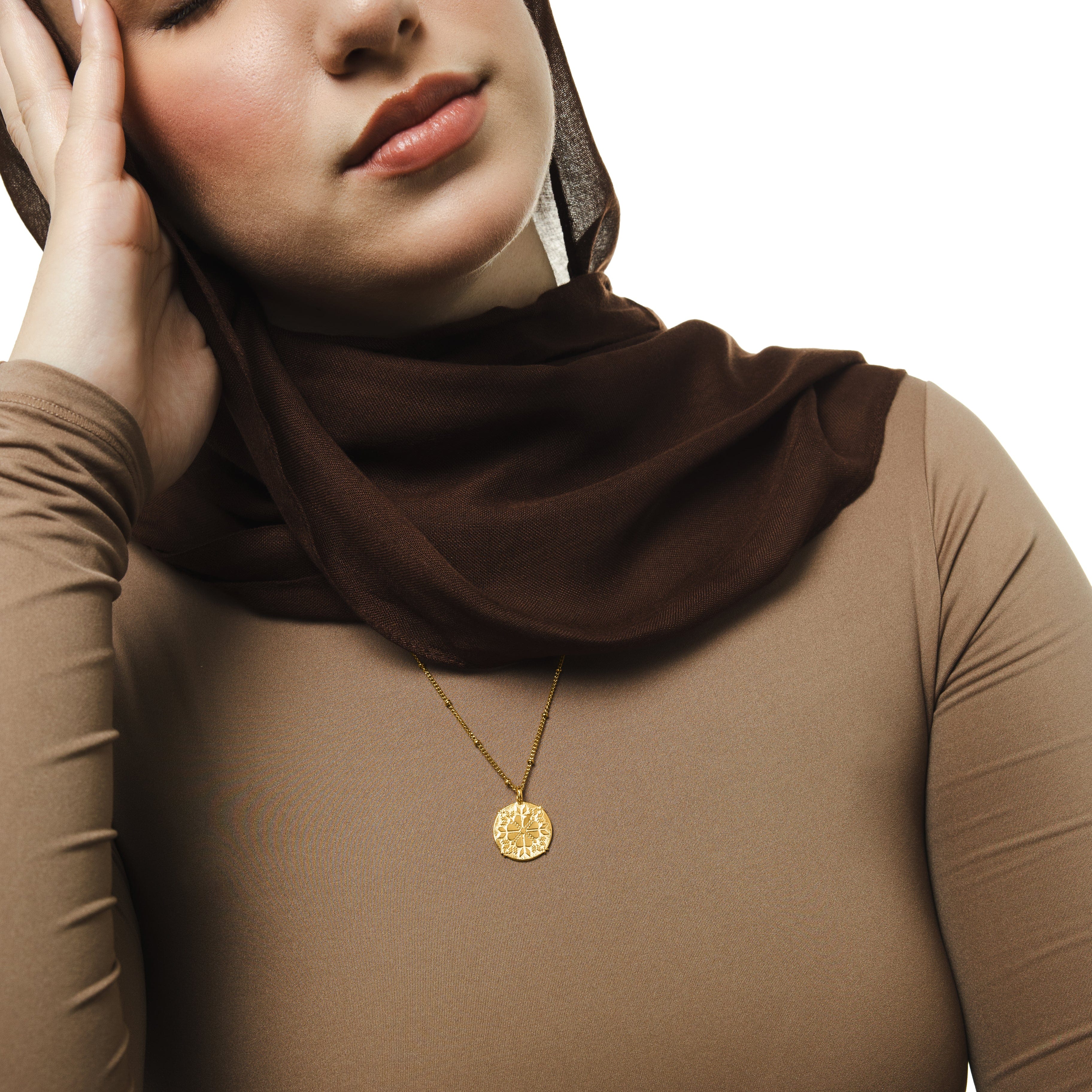 Tatreez necklace worn by a model, demonstrating its versatility and cultural significance.