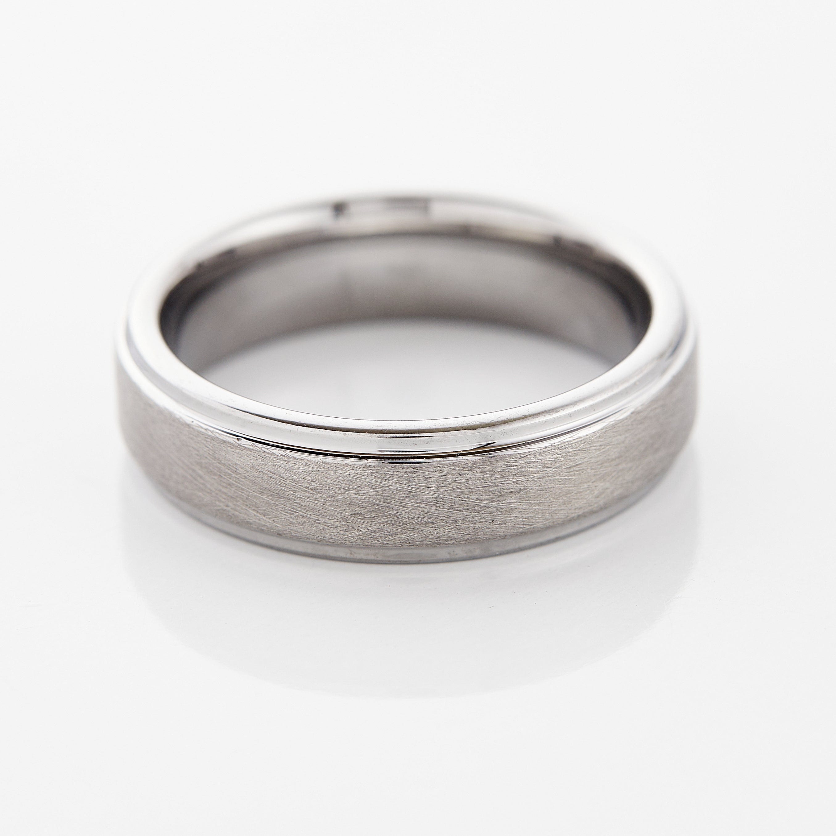 Textured tungsten wedding band worn on a mans hand, demonstrating its daily wear suitability.
