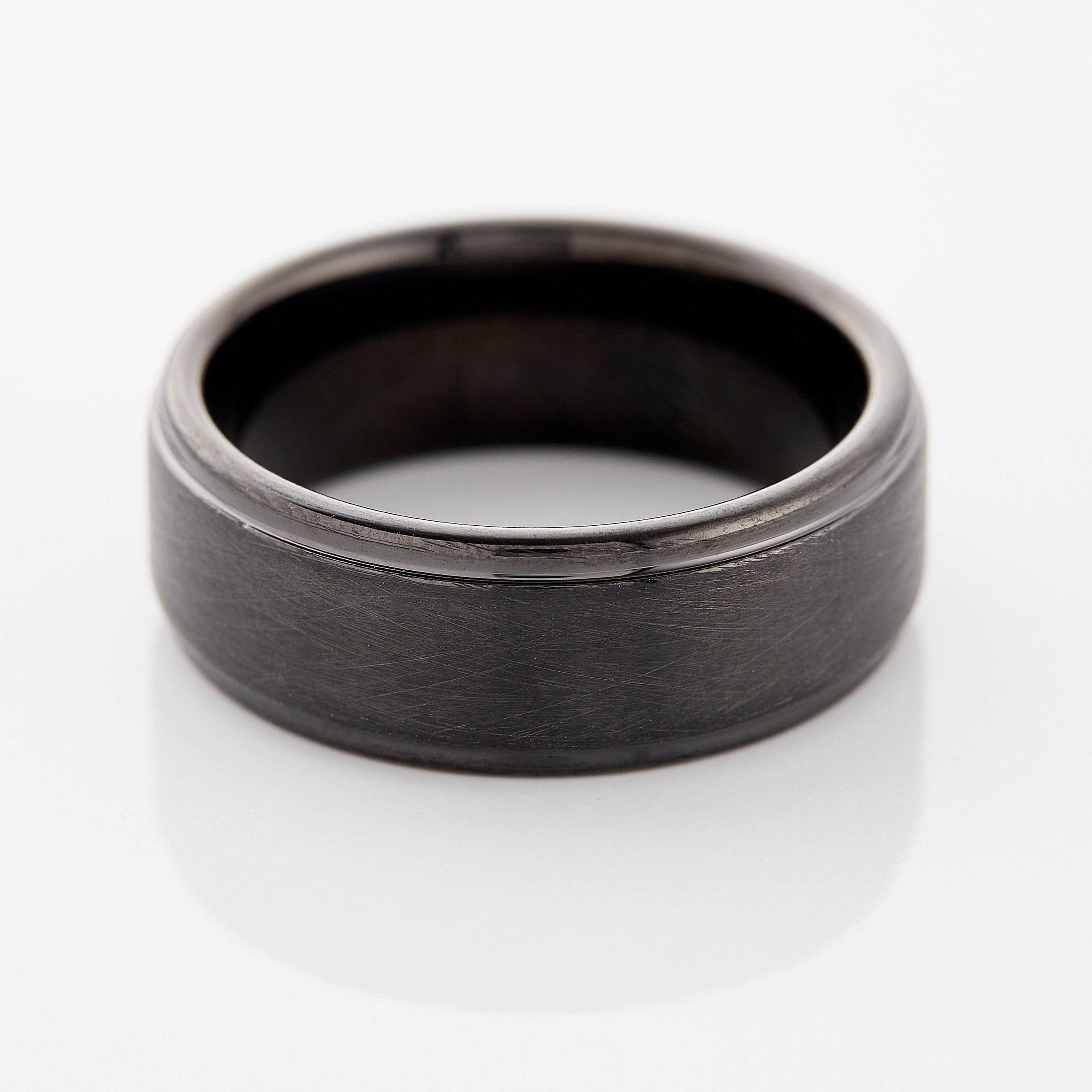 Textured tungsten wedding band worn on a mans hand, demonstrating its daily wear suitability.