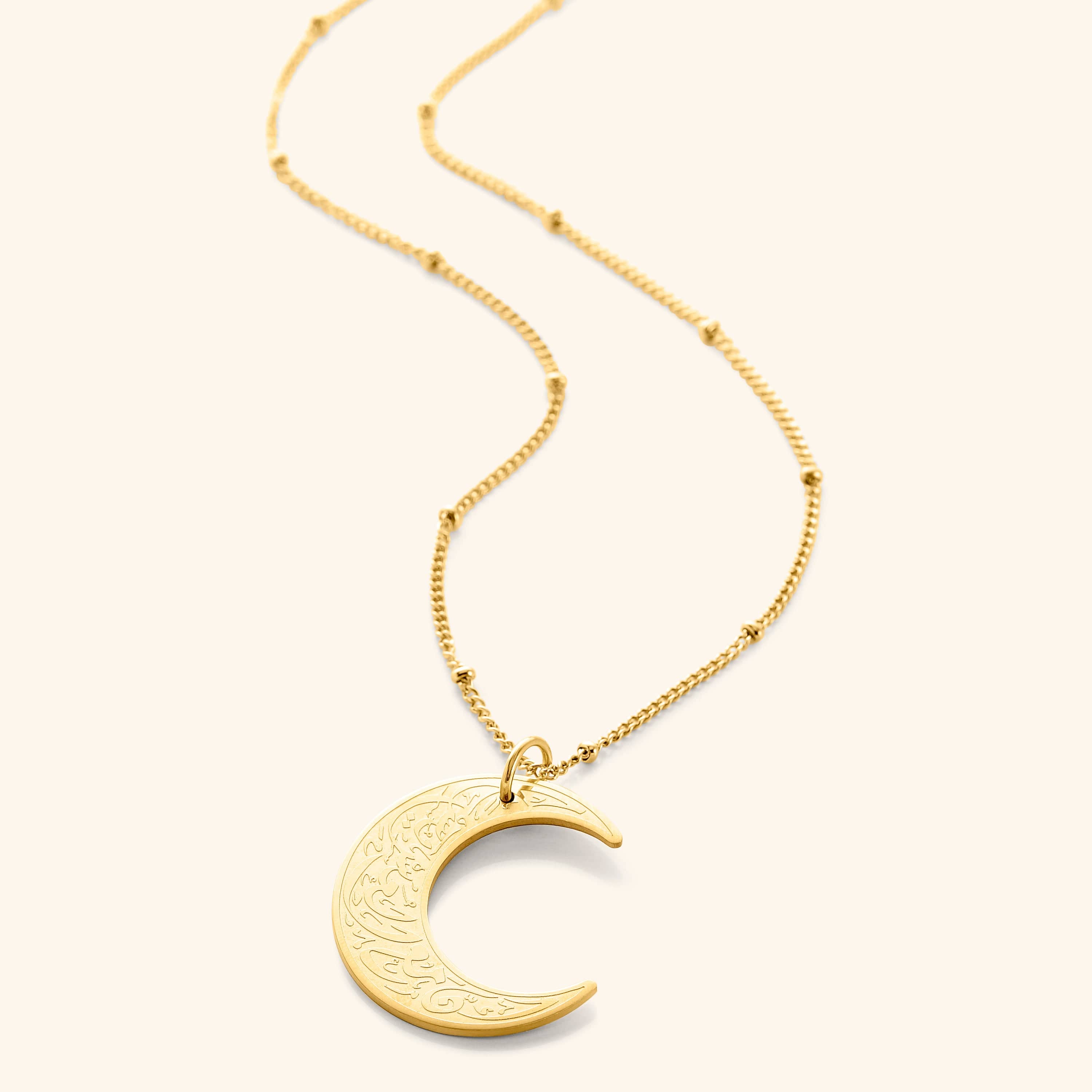 Crescent of Resilience Necklace worn by a model, highlighting its elegant design and Arabic calligraphy.