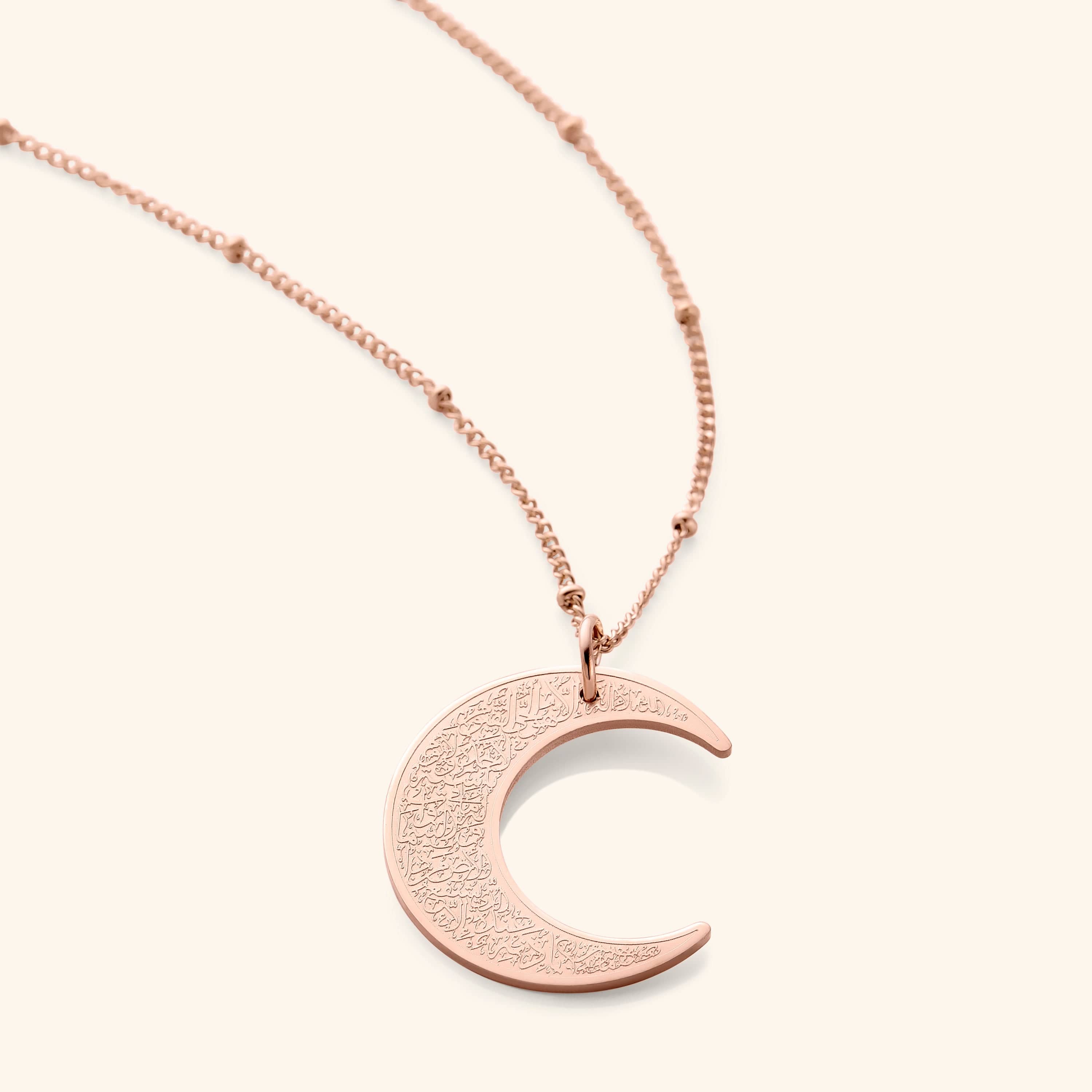 Close-up of the Ayatul Kursi crescent necklace showcasing detailed engravings.