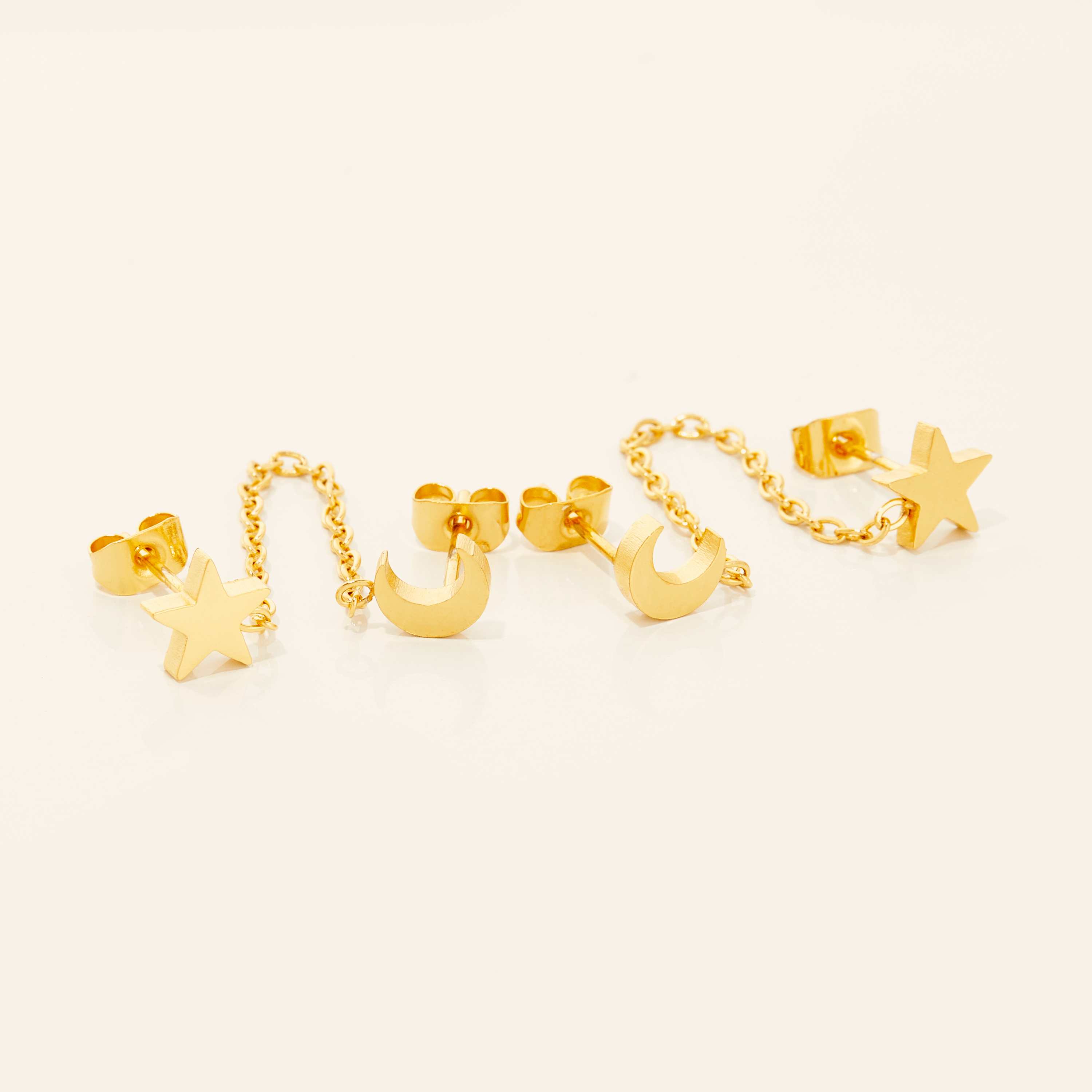 Close-up of Celestial Double-Stud Chain Earrings showcasing the 18K gold plating.