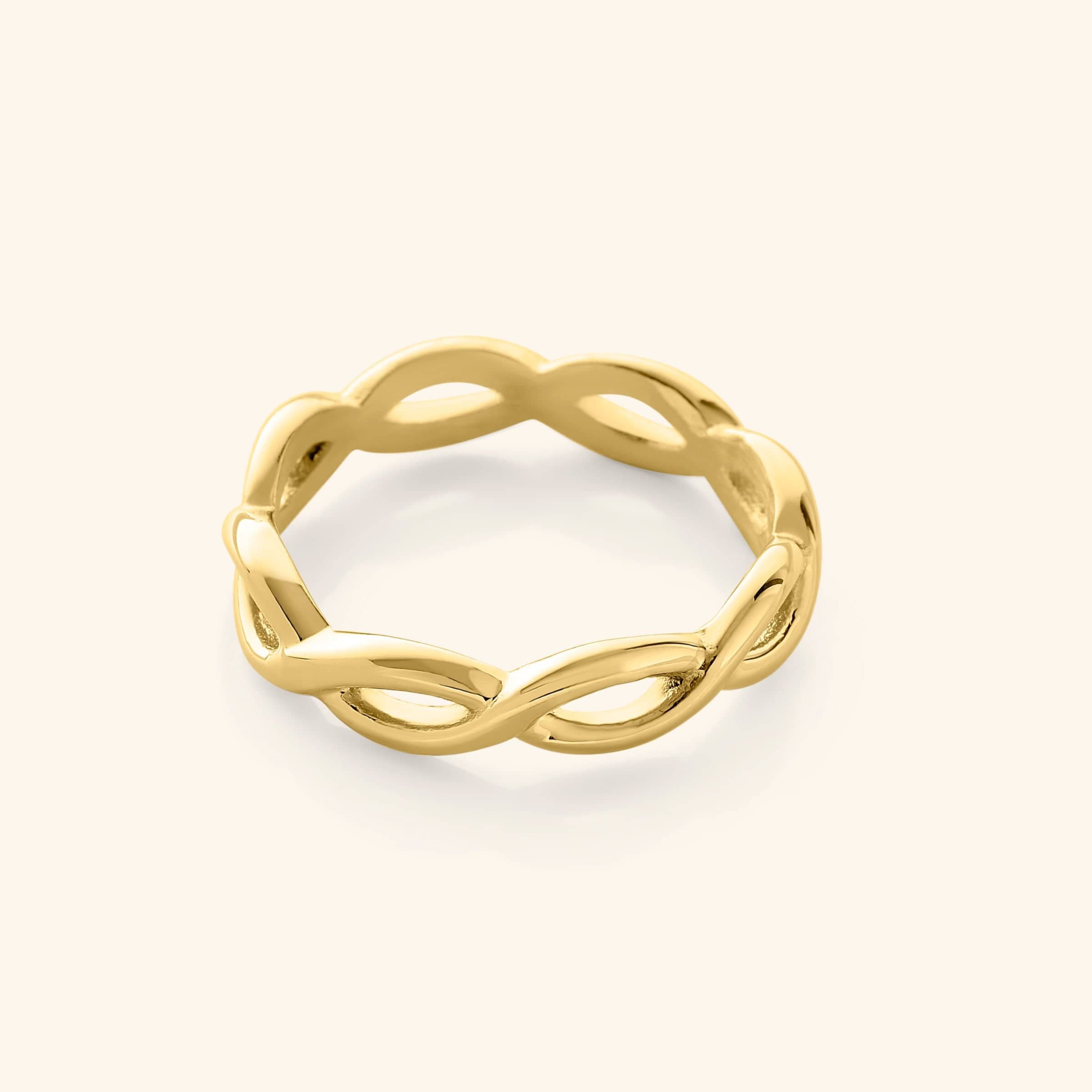 Close-up of the EternaGlow gold infinity ring showing its spiral design and 18K finish