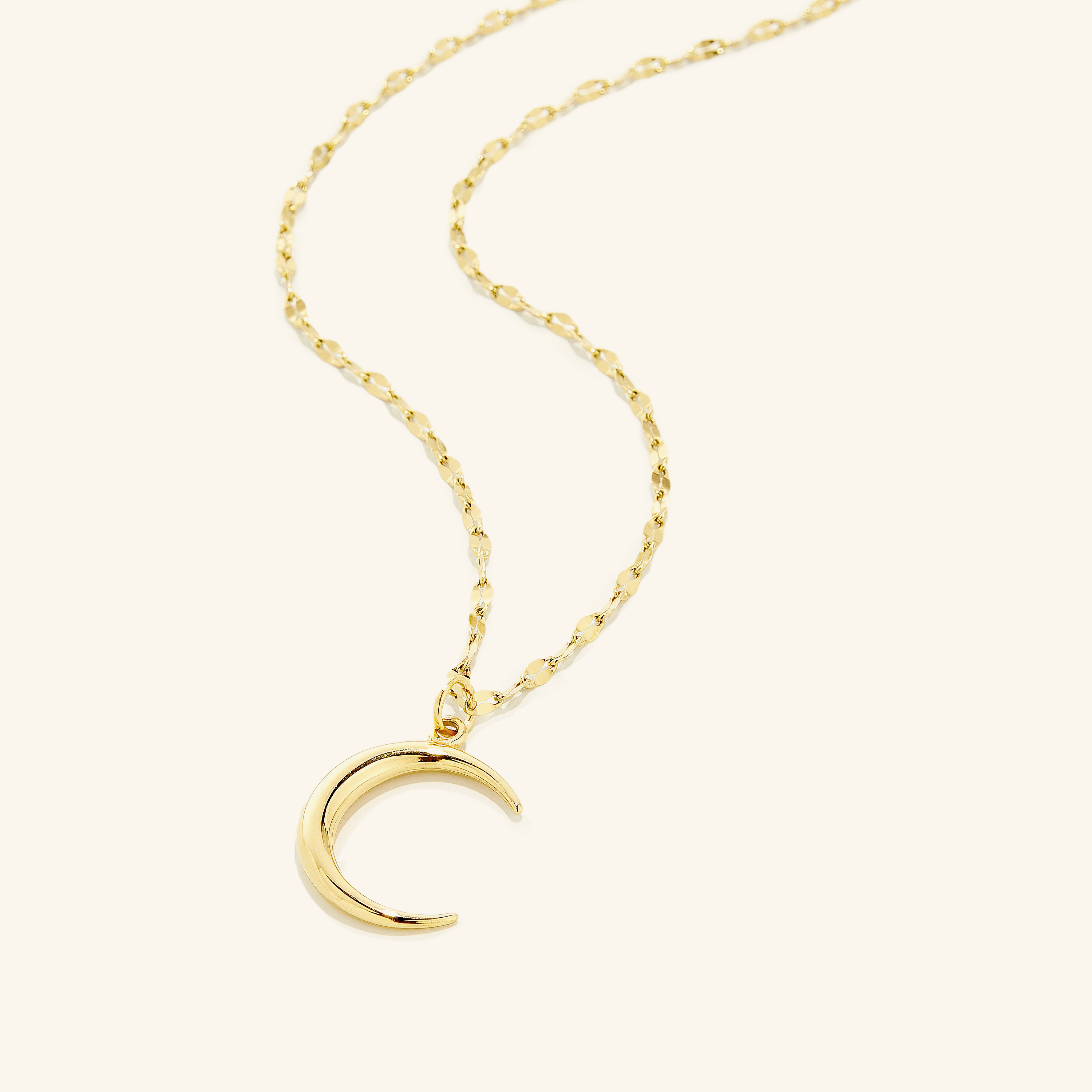 Elegant 3D Crescent Necklace showcased against a dark background, highlighting its shiny finish.