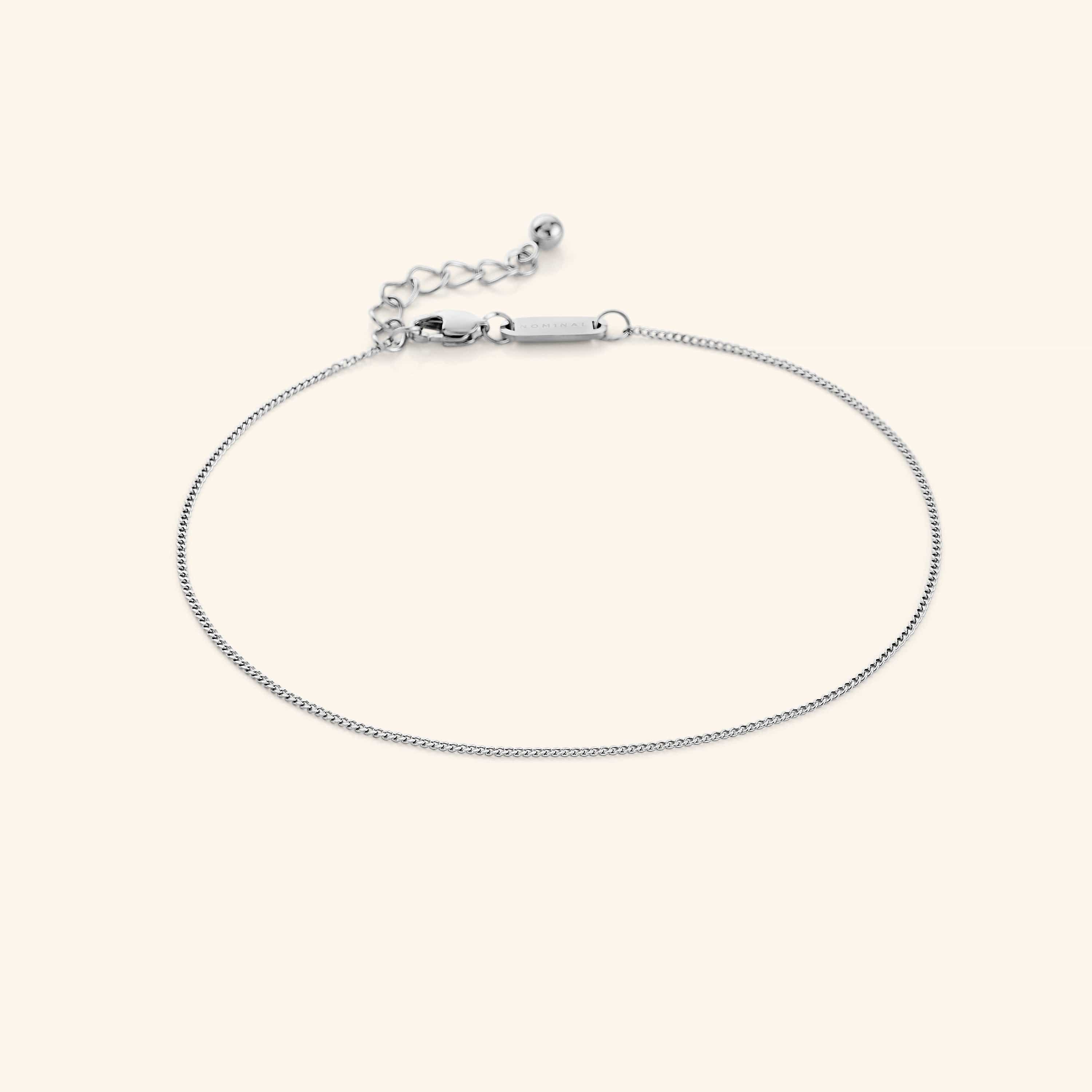 Invisible Curb Anklet on a models ankle, showcasing its elegant design and fit.