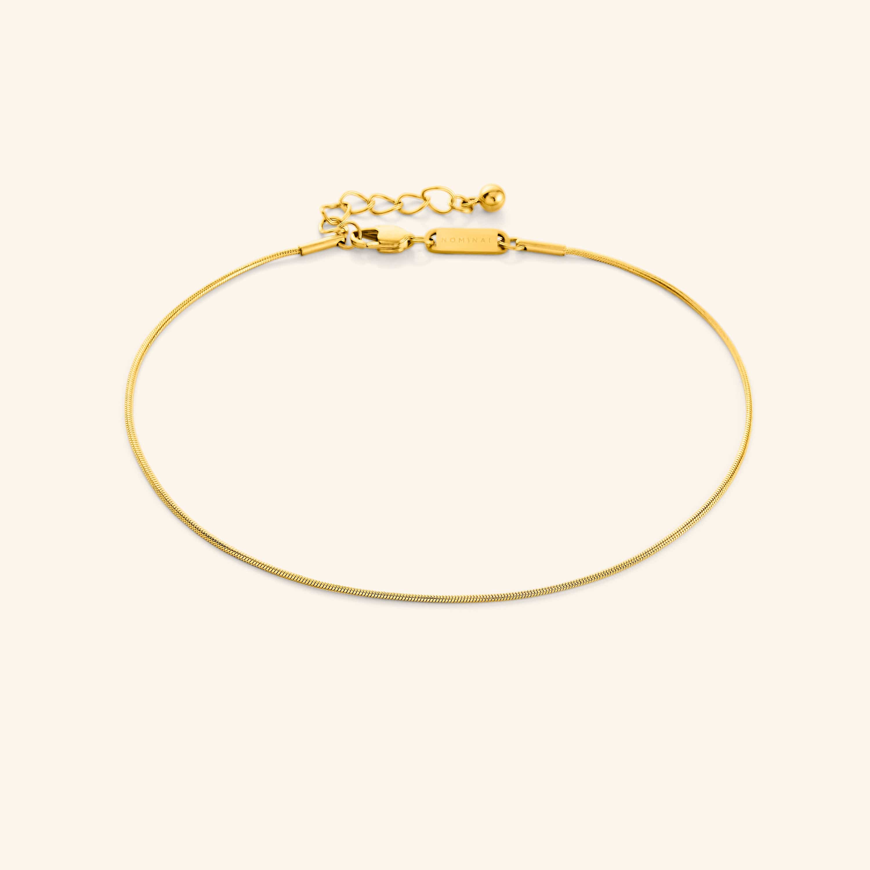 Elegant Harmony Gold Anklet displayed on a model's ankle, showcasing its delicate design.