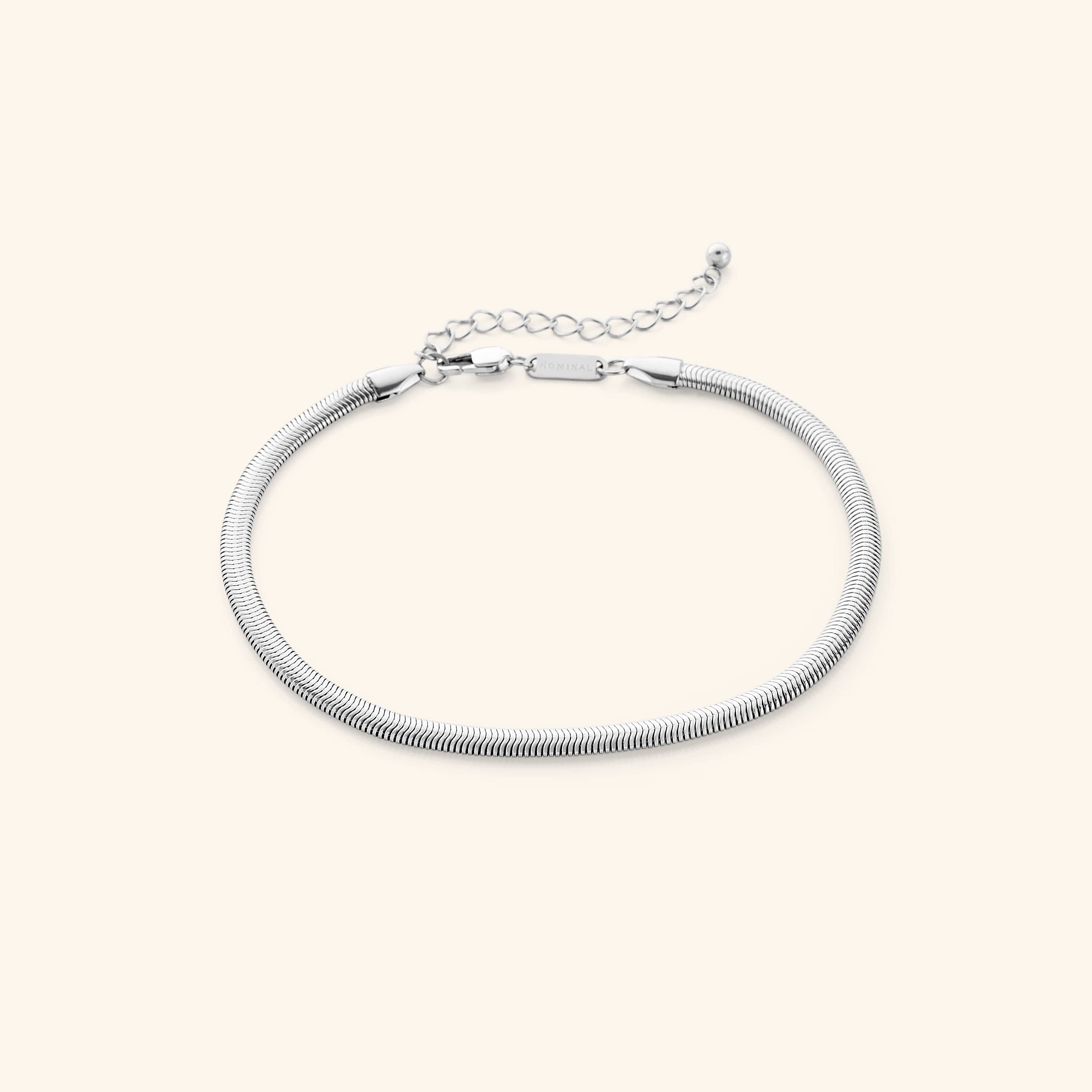Close-up of the snake anklet showing the 18K gold plating and rounded edges, perfect for sensitive skin.