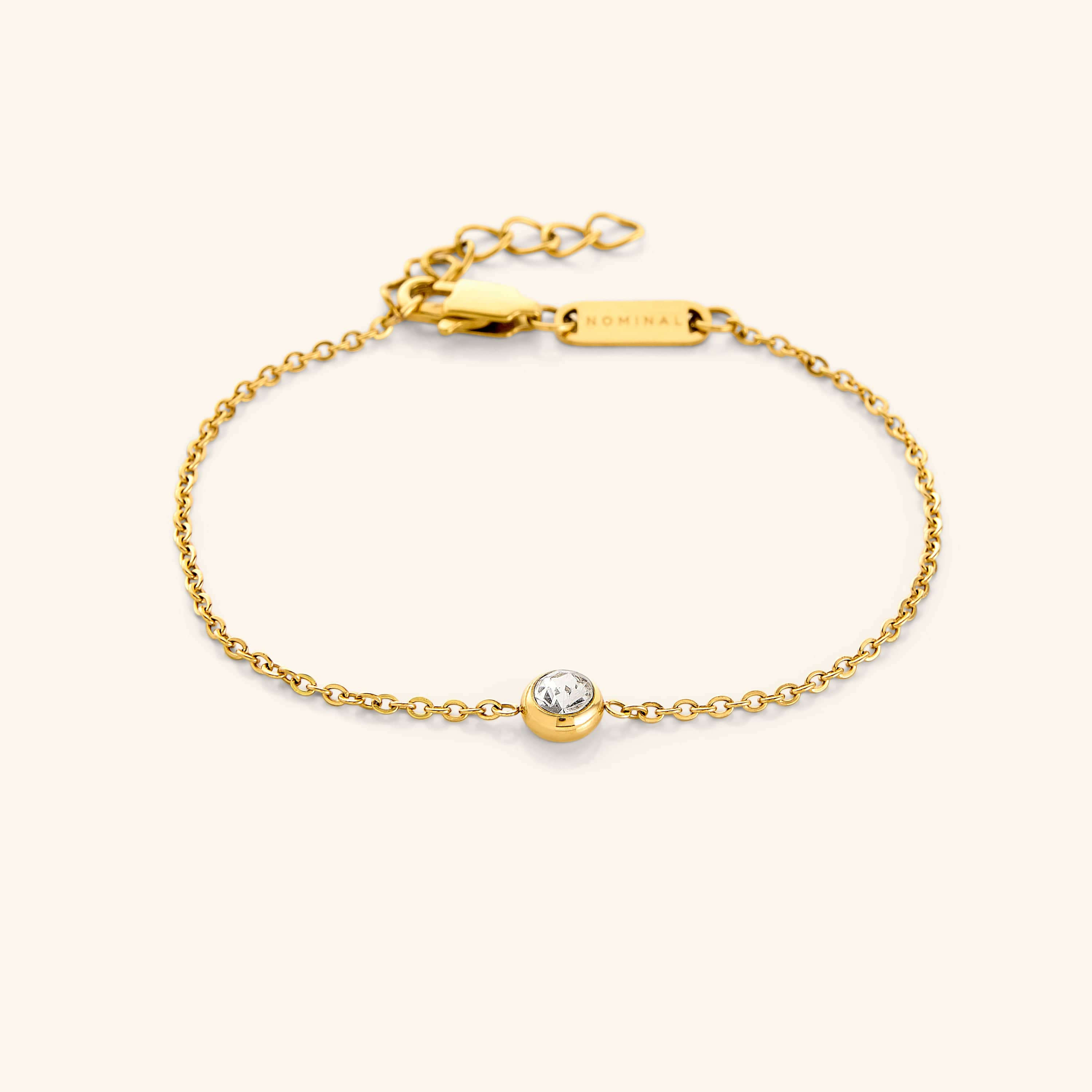 Elegant gemstone bezel bracelet displayed on a soft velvet surface, showcasing its shiny finish.