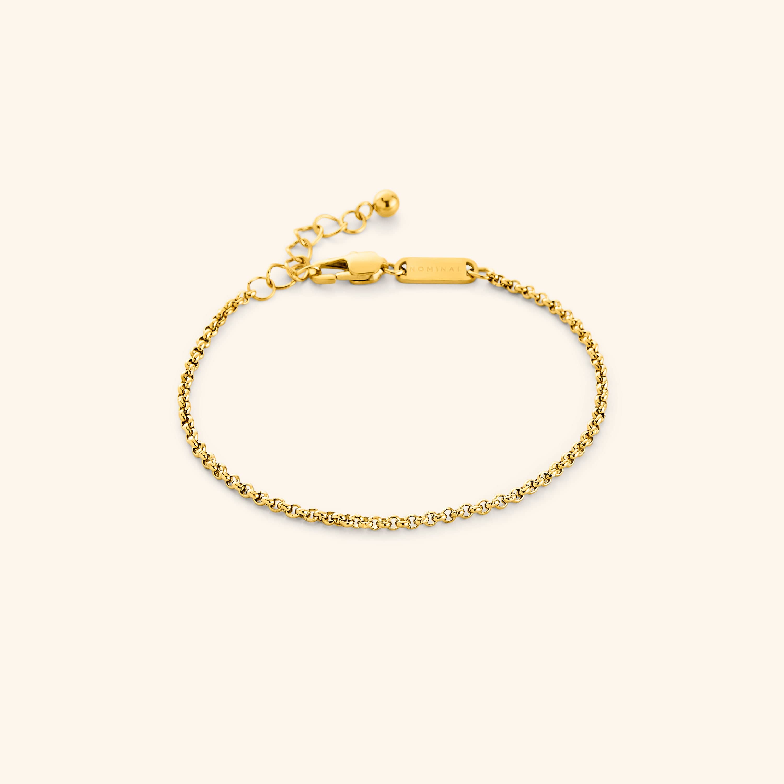 Elegant Invisible Box Bracelet displayed on a velvet pouch, highlighting its gold finish and delicate chain design.