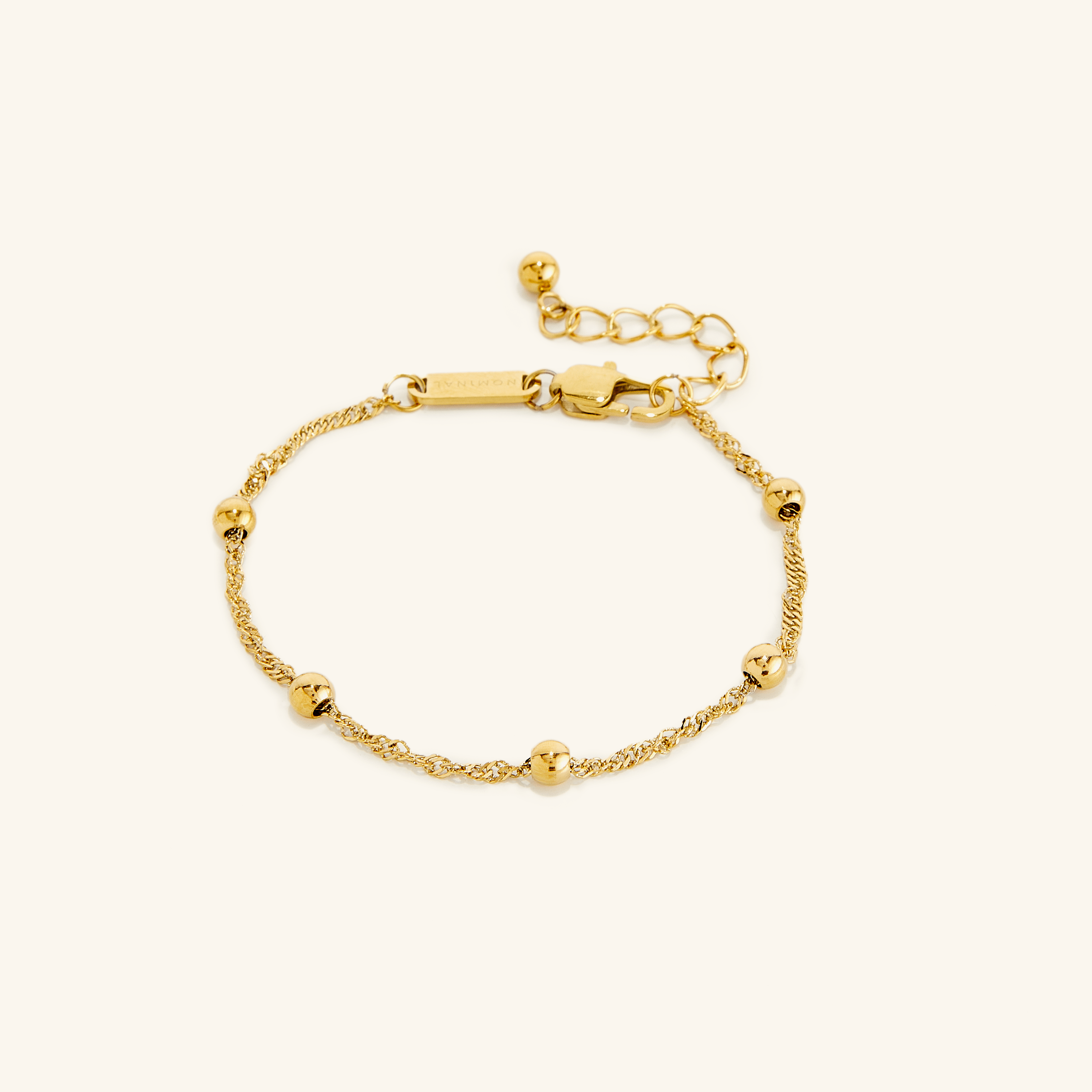 Close-up of the Elegant Dotted Twisted Bracelet highlighting its dotted beads and gold finish.