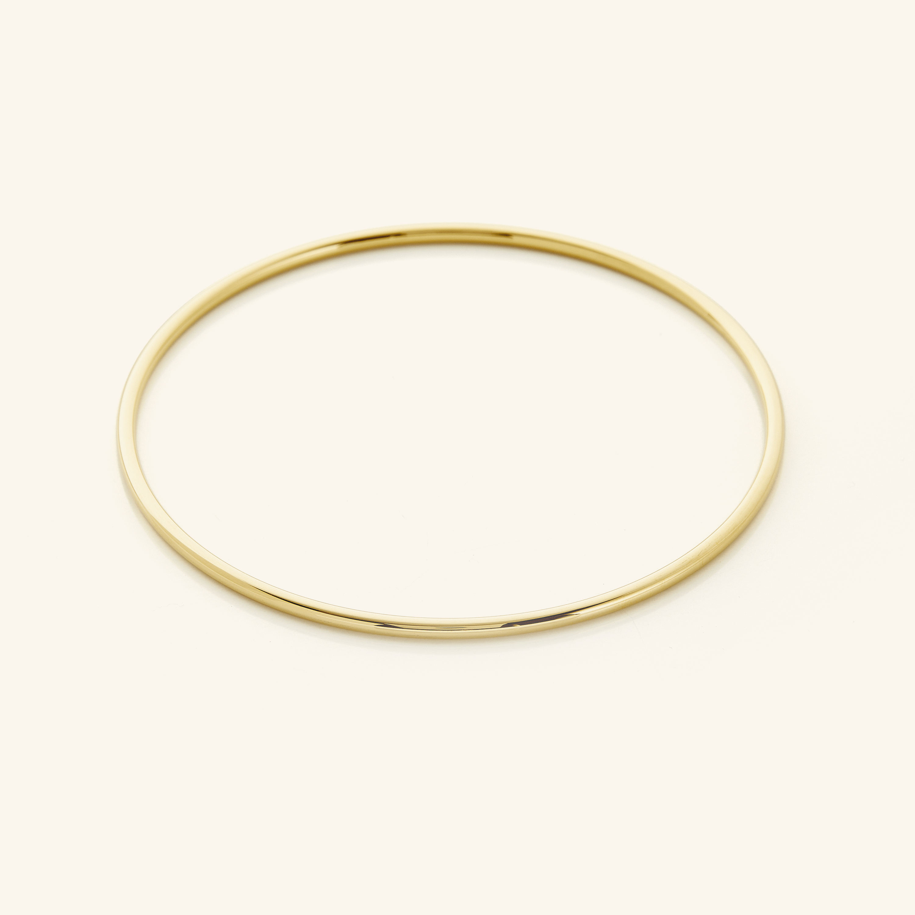 Elegant gold thin bangle worn casually by a model