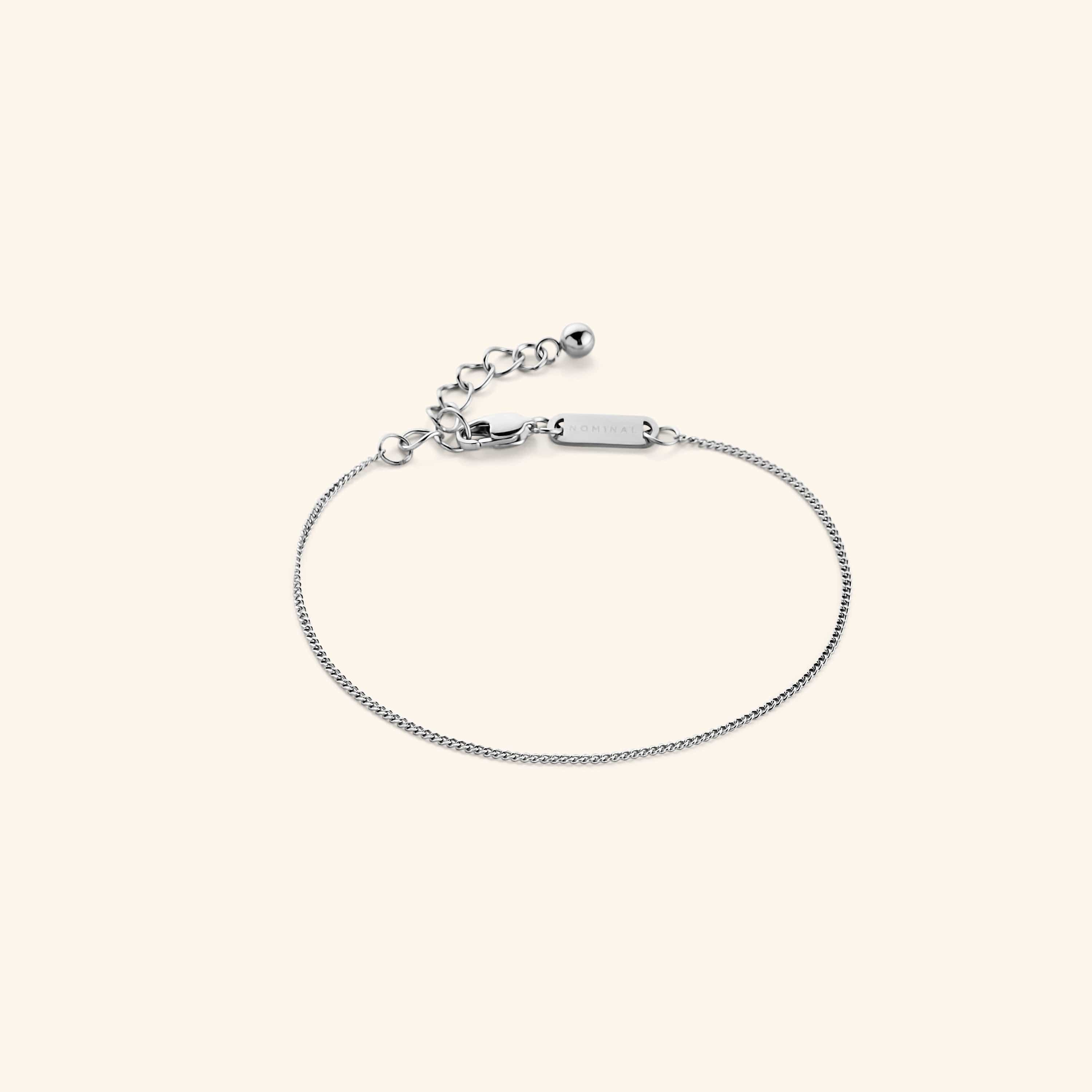 Close-up of the Invisible Curb Gold Bracelet showcasing its 1MM flat oval chain design, perfect for fashion lovers.
