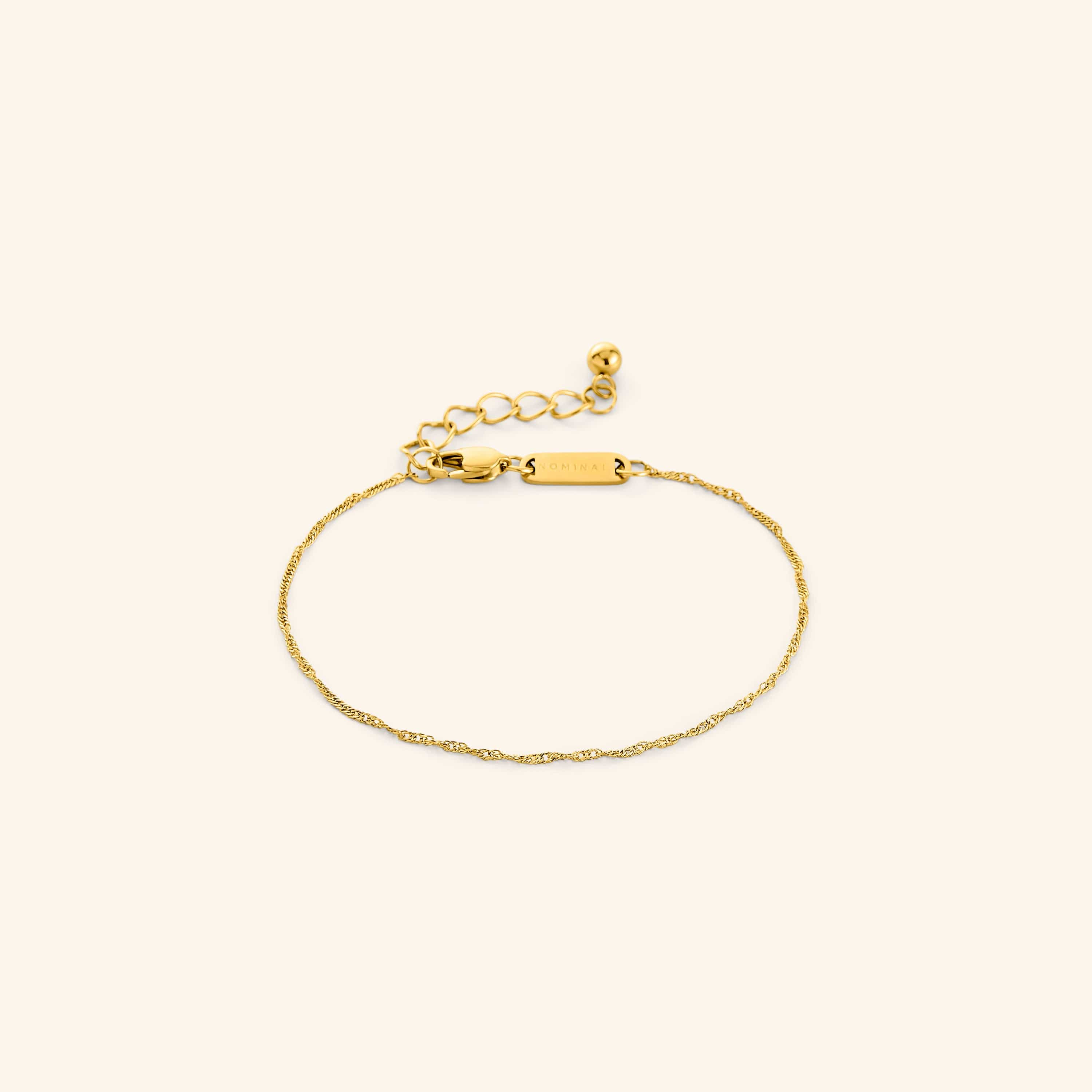 Elegant twisted gold bracelet showcasing its delicate chain design.